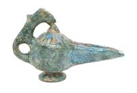 A Middle Eastern Glazed Earthenware Oil Lamp, Height 5 1/2 inches.