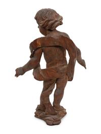 An Italian Carved Walnut Figure of Putto