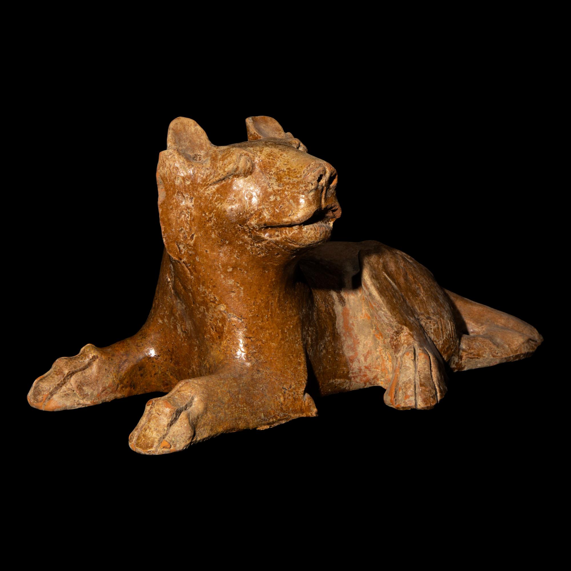 A Chinese Straw Glazed Pottery Figure of a Recumbent Dog, Han Dynasty 漢 陶臥犬