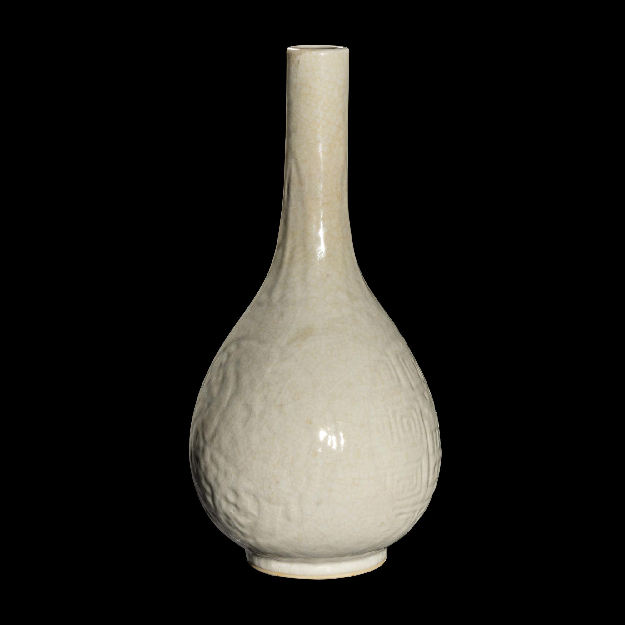 A Chinese Molded White Glazed Porcelain Bottle Vase, 18th/19th Century 清中期 白釉模印如意纹膽瓶