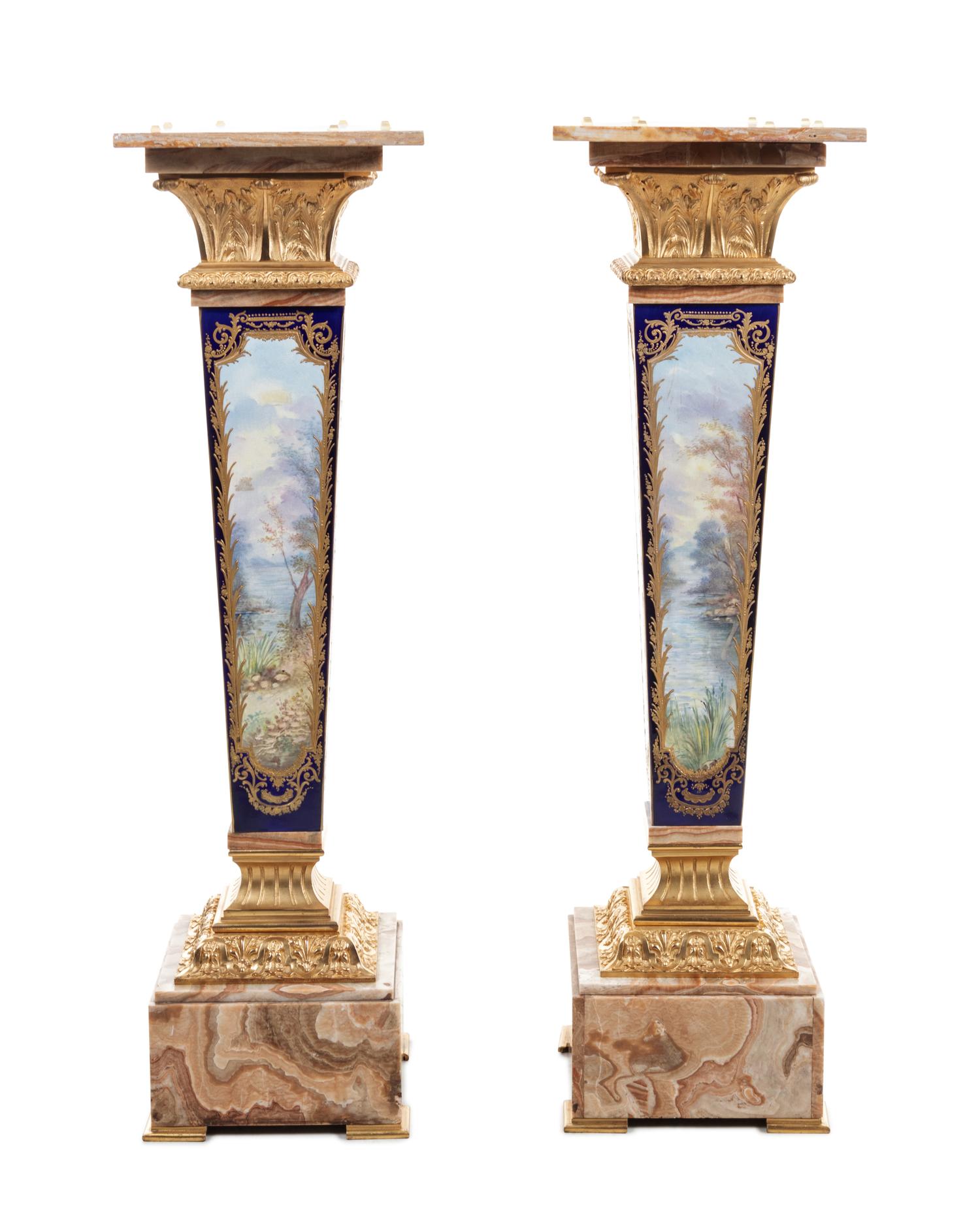 A Pair of Sèvres Style Gilt Bronze Mounted Painted and Parcel Gilt Porcelain and Onyx Pedestals