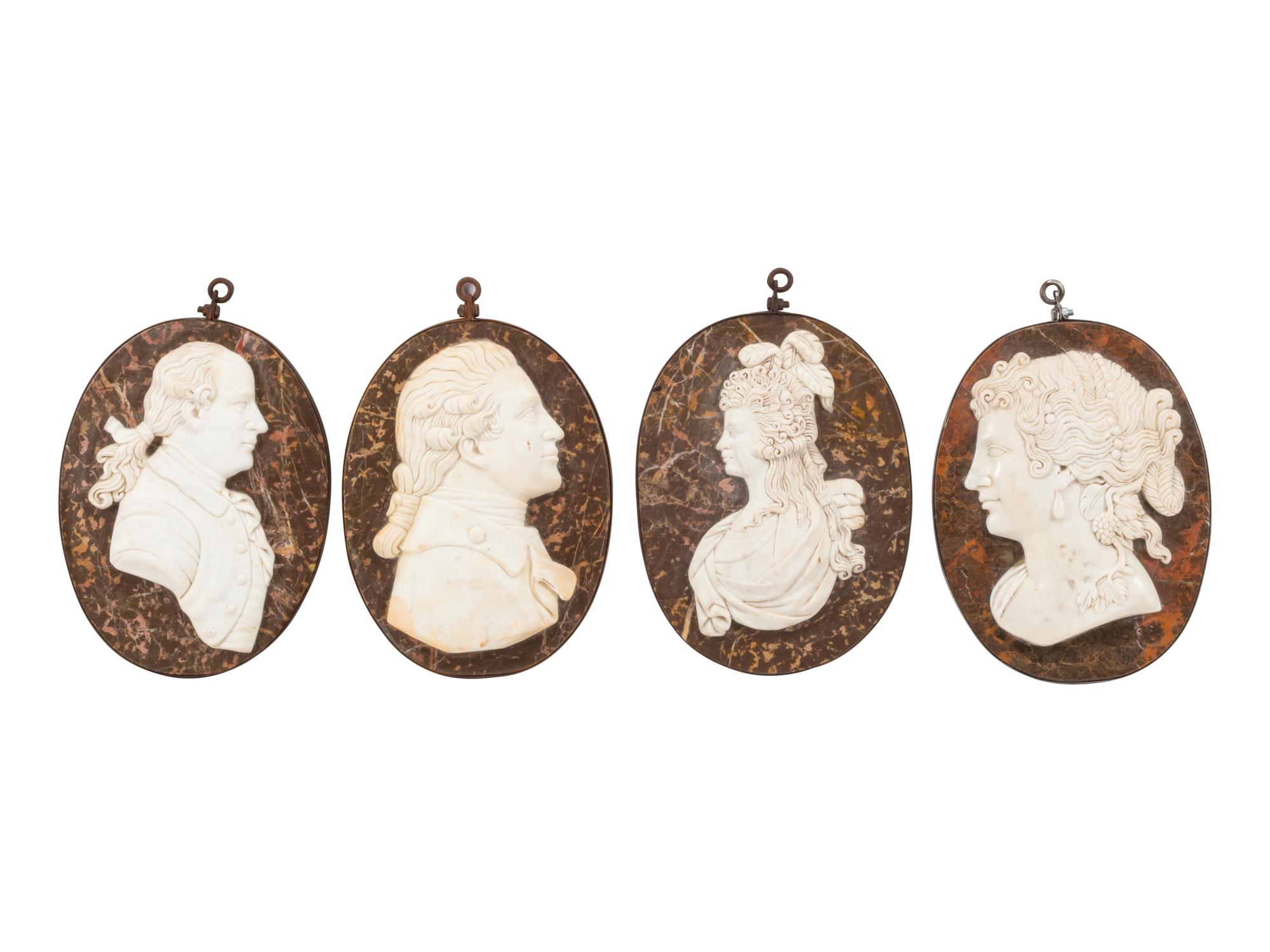 A Set of Four Italian Carved Marble and Iron Mounted Profile Medallions
