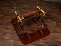 A Classical Parcel Gilt and Ebonized, Figured Mahogany Paw-Foot Drop-Leaf Table