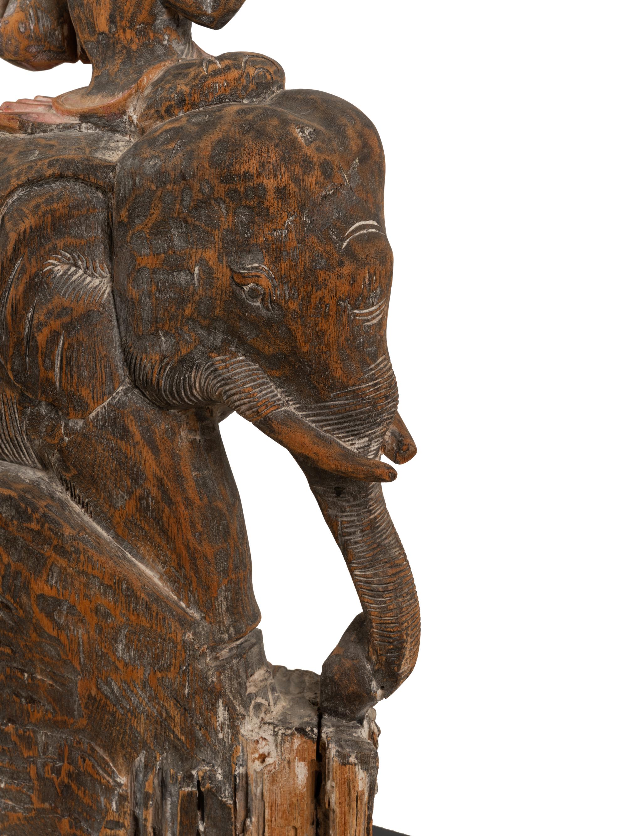 A Southeast Asian Carved and Painted Wood Group of an Elephant and Rider
