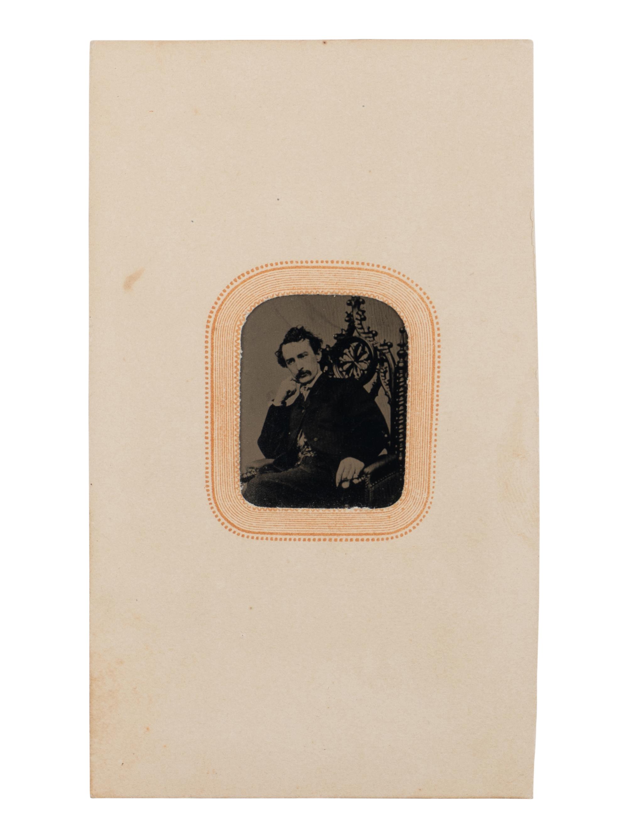 [BOOTH, John Wilkes (1838-1865)]. Tintype depicting a seated John Wilkes Booth, ca 1864.