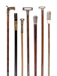 Seven Silvered Metal and Brass Mounted Smoker's System Walking Sticks
