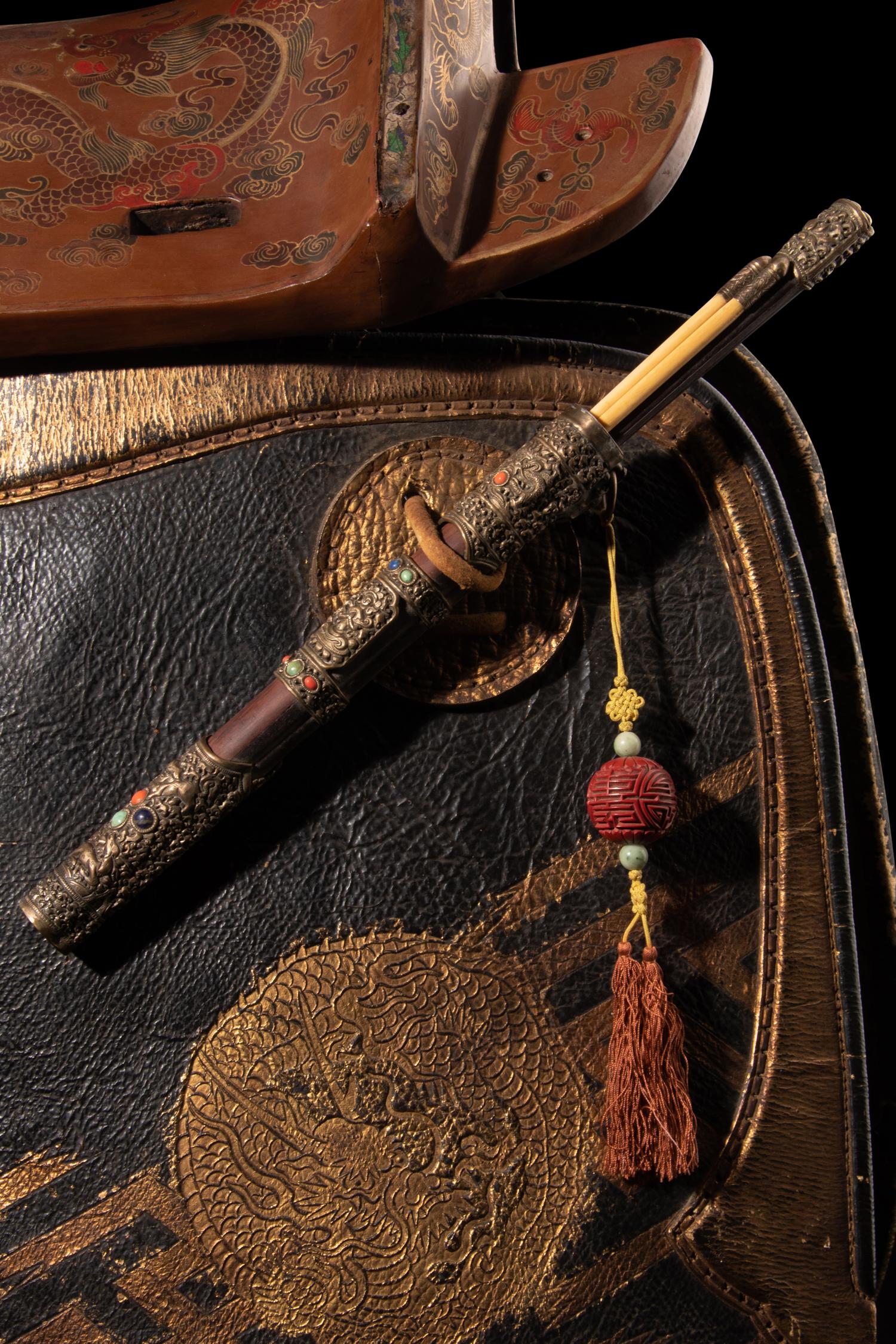 A Gilt and Polychrome Painted Red Lacquer Saddle and Two Pads