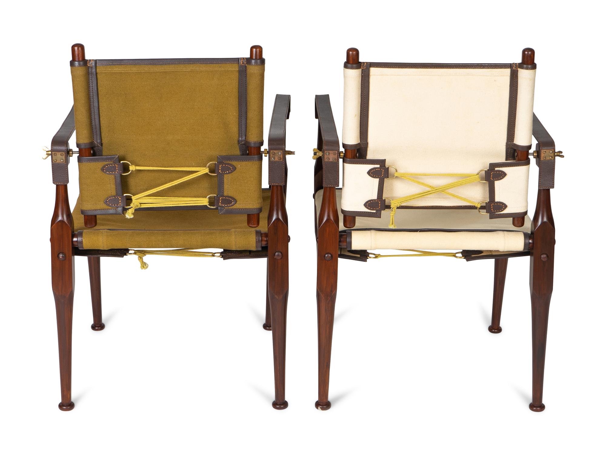 A Pair of British Colonial Style Mahogany, Canvas and Leather Strap Campaign Chairs — 20TH CENTURY