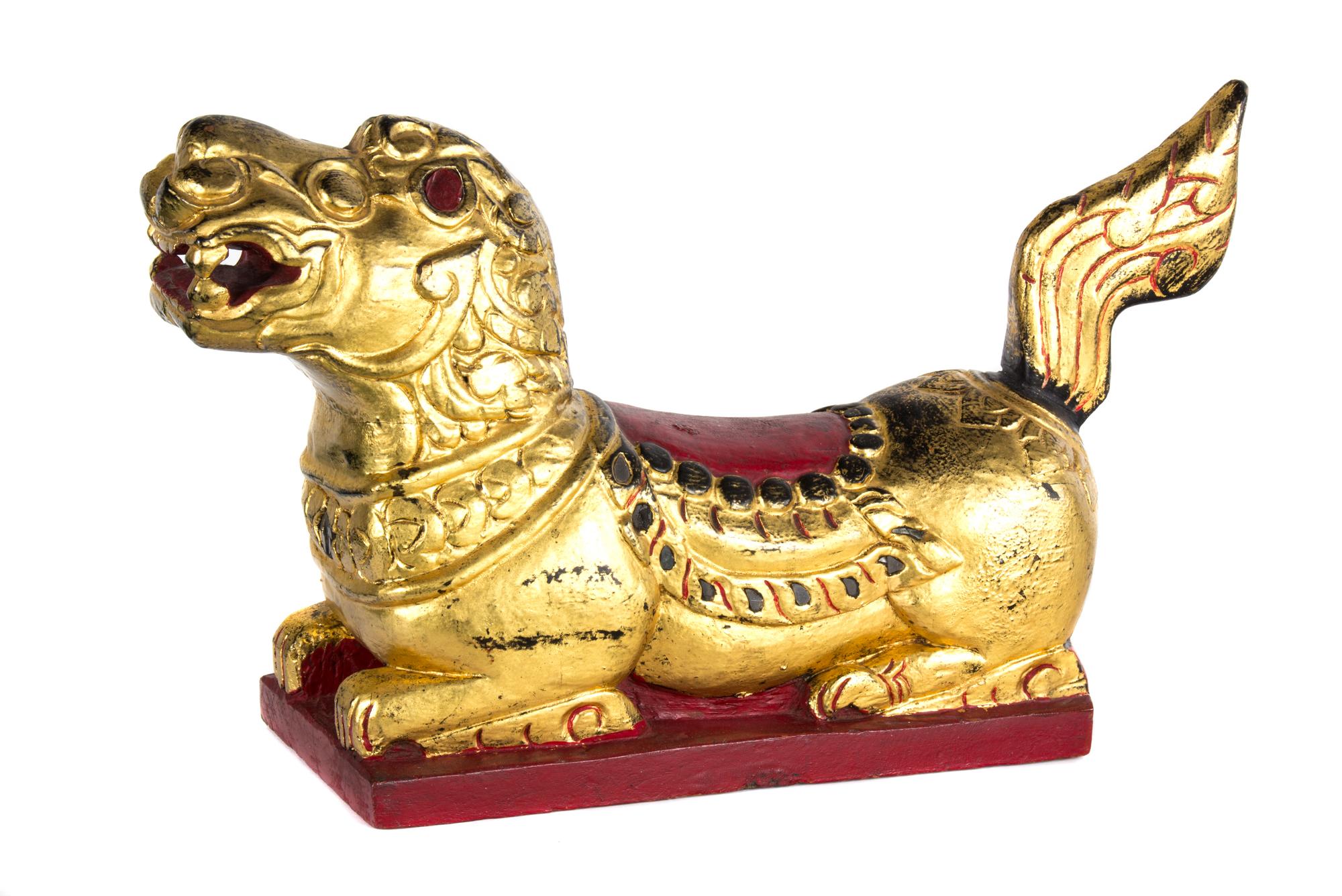 A Southeast Asian Giltwood Model of a Recumbent Beast Width 24 inches.