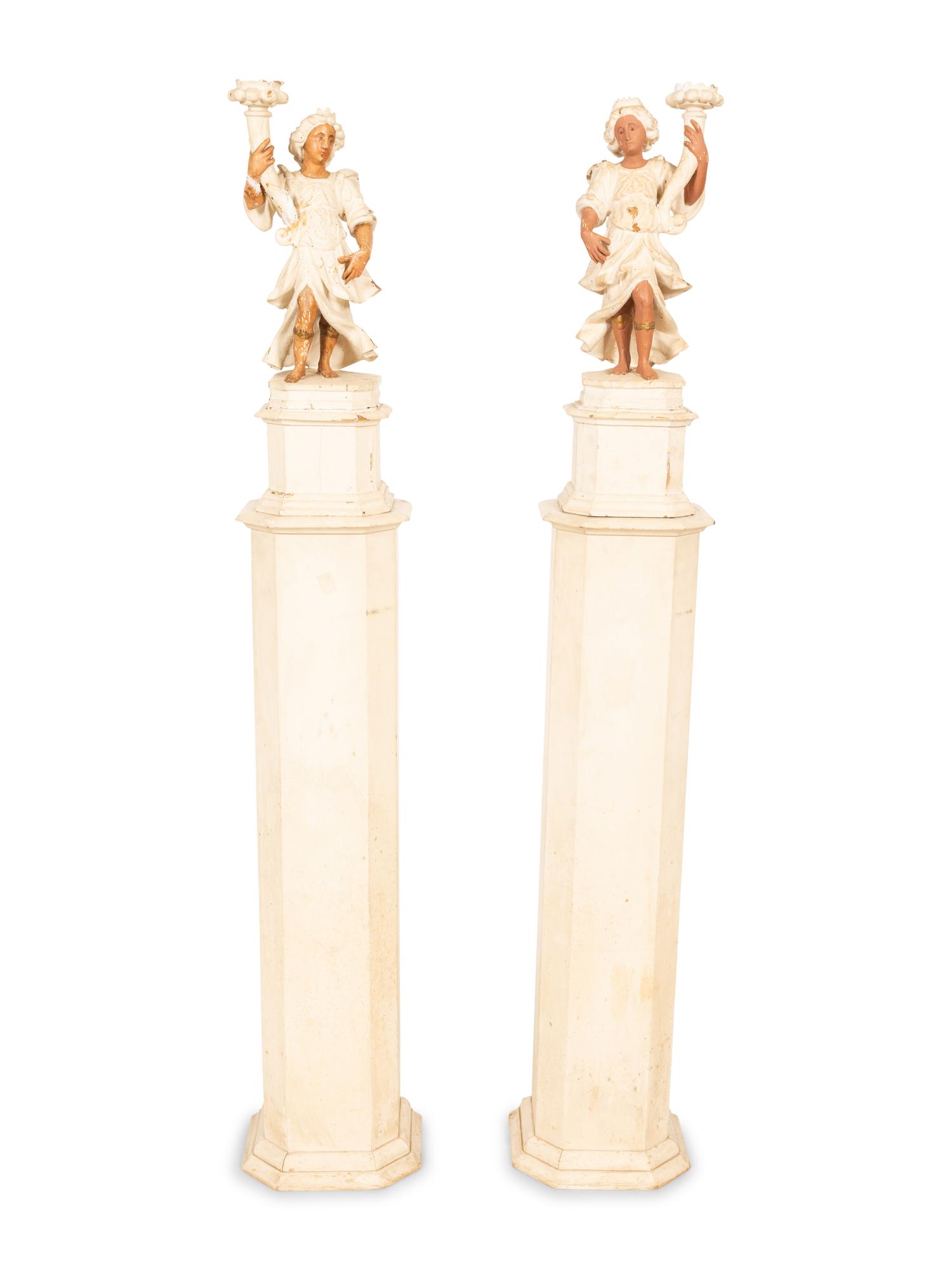 A Pair of Italian Painted Figural Candelsticks on Pedestal Bases