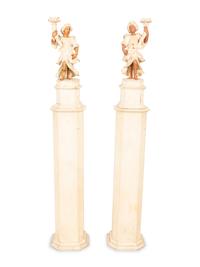 A Pair of Italian Painted Figural Candelsticks on Pedestal Bases