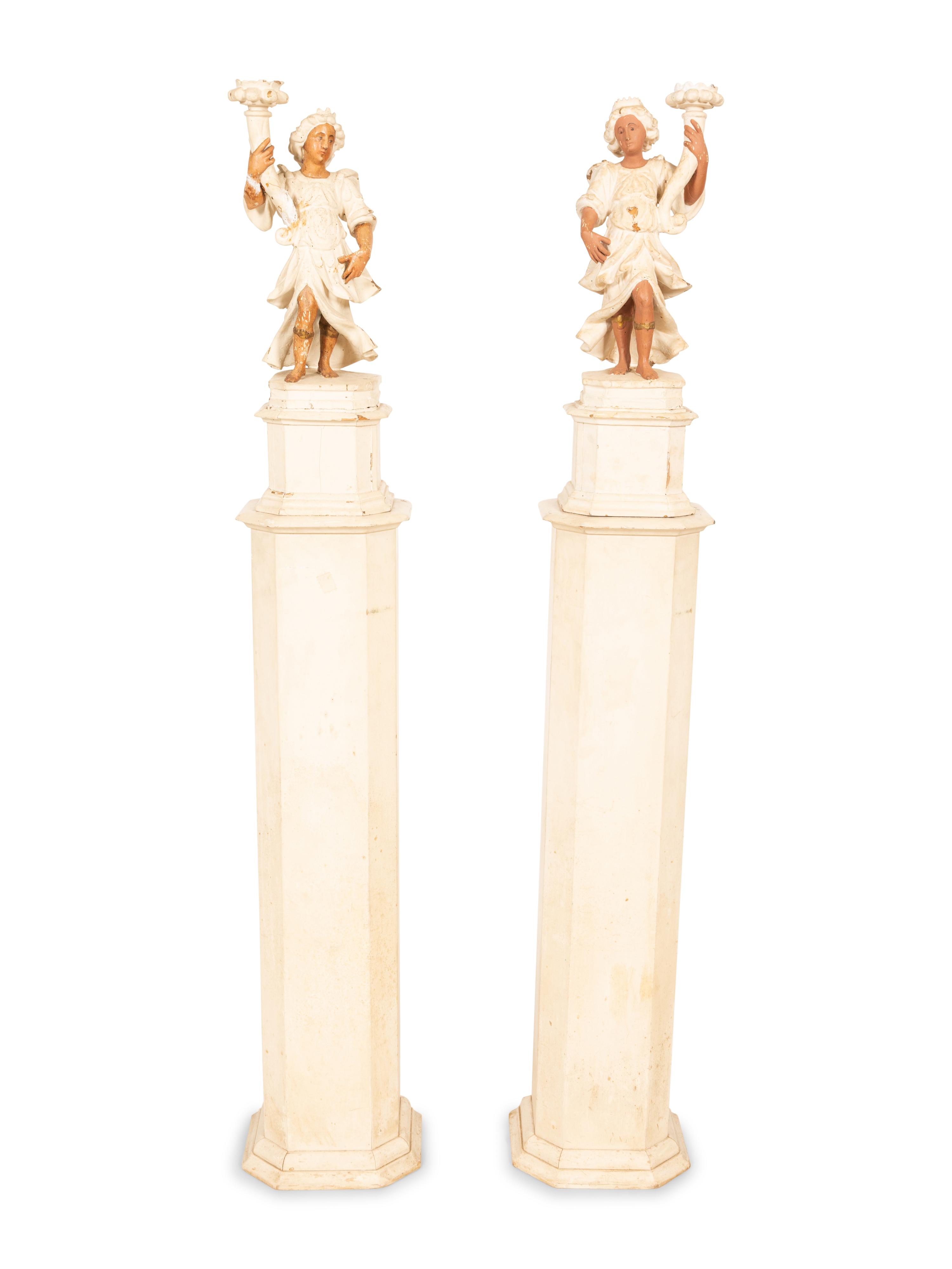 A Pair of Italian Painted Figural Candelsticks on Pedestal Bases