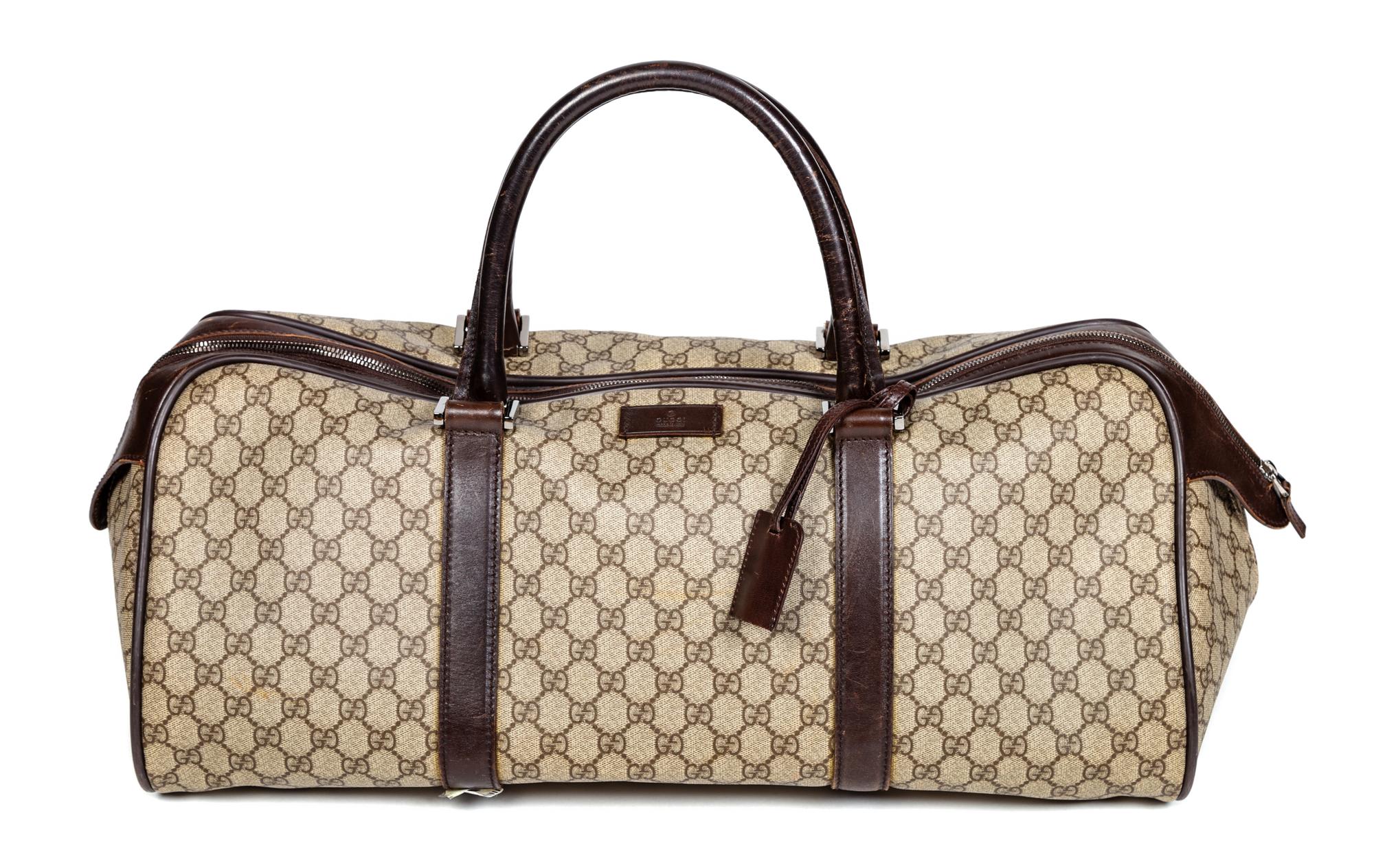 A Gucci Monogram Canvas Duffle Bag, 9.5" H x 21.5" W x 10.5" D; Handle drop: 6".