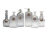 Fifteen Glass Decanters with English Shell-Form Silver Bottle Tags