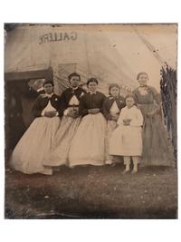 [EARLY PHOTOGRAPHY]. Tintype featuring a group of women standing outside of a Civil War photographer's tent, possibly at Camp Parole, Annapolis, MD.