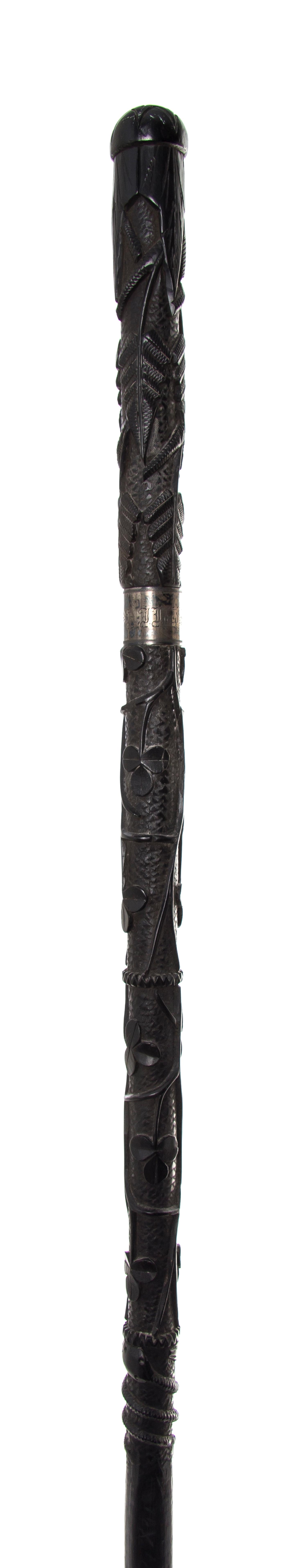 An Irish Carved Wood Walking Stick, Length of handle 6 x length overall 34 1/2 inches.