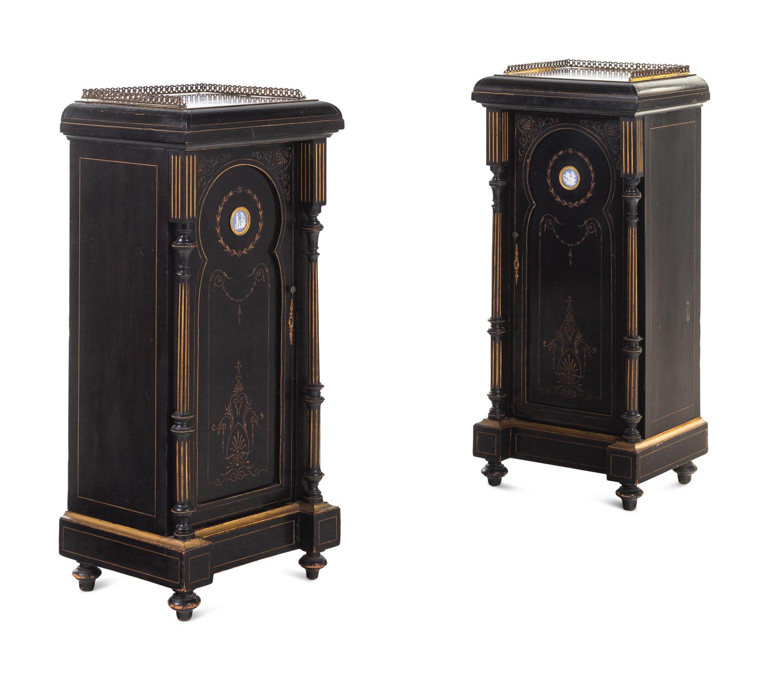 A Pair of English Aesthetic Jasperware Medallion-Mounted Ebonized and Parcel-Gilt Pedestal Cabinets