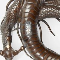A Japanese patinated bronze dragon and rock crystal sphere Meiji period