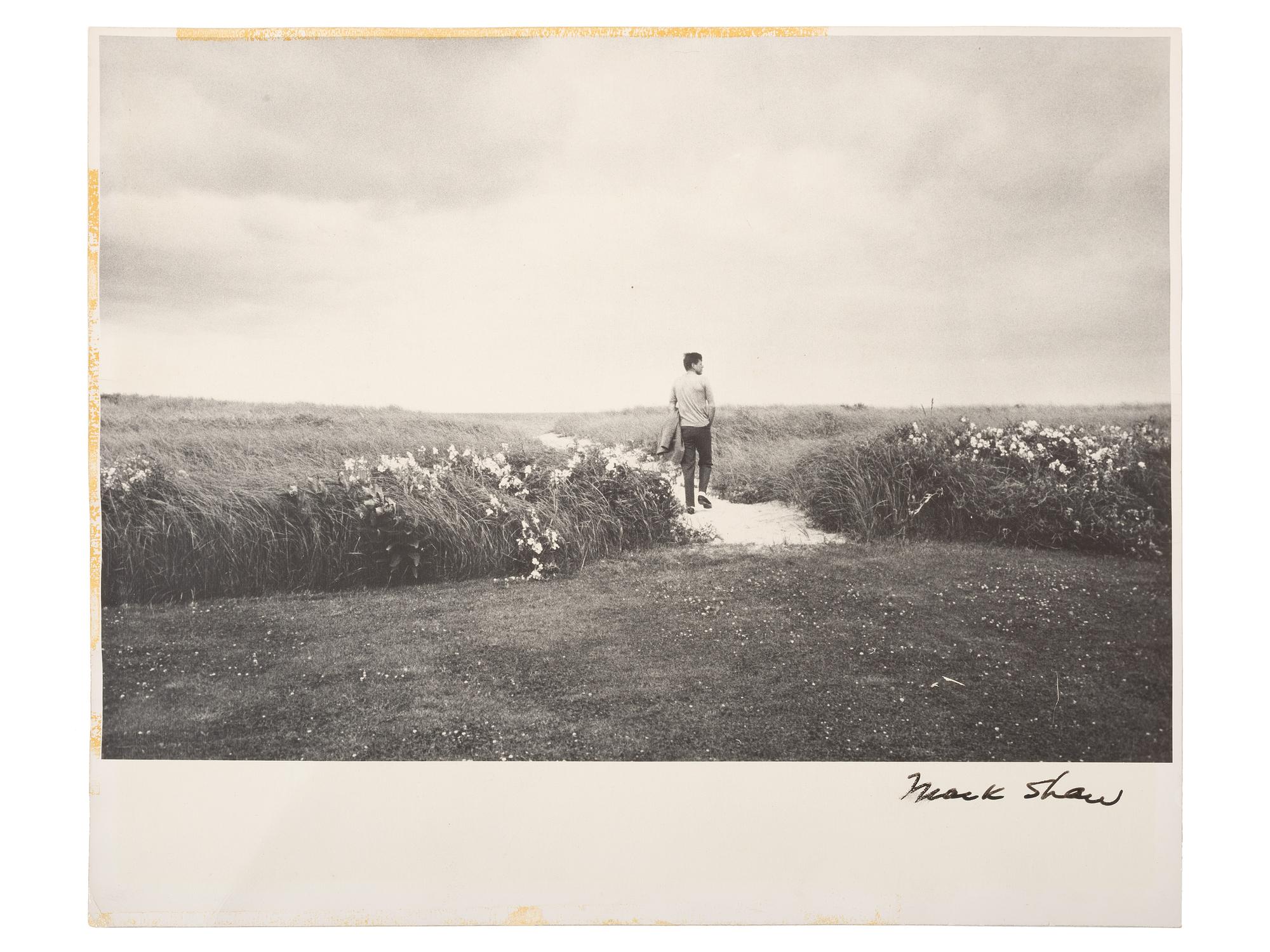 [KENNEDY, John F. (1917-1963)]. SHAW, Mark (1921-1969), photographer. Photograph of John F. Kennedy on the dunes near Hyannis Port. New York: 1961.