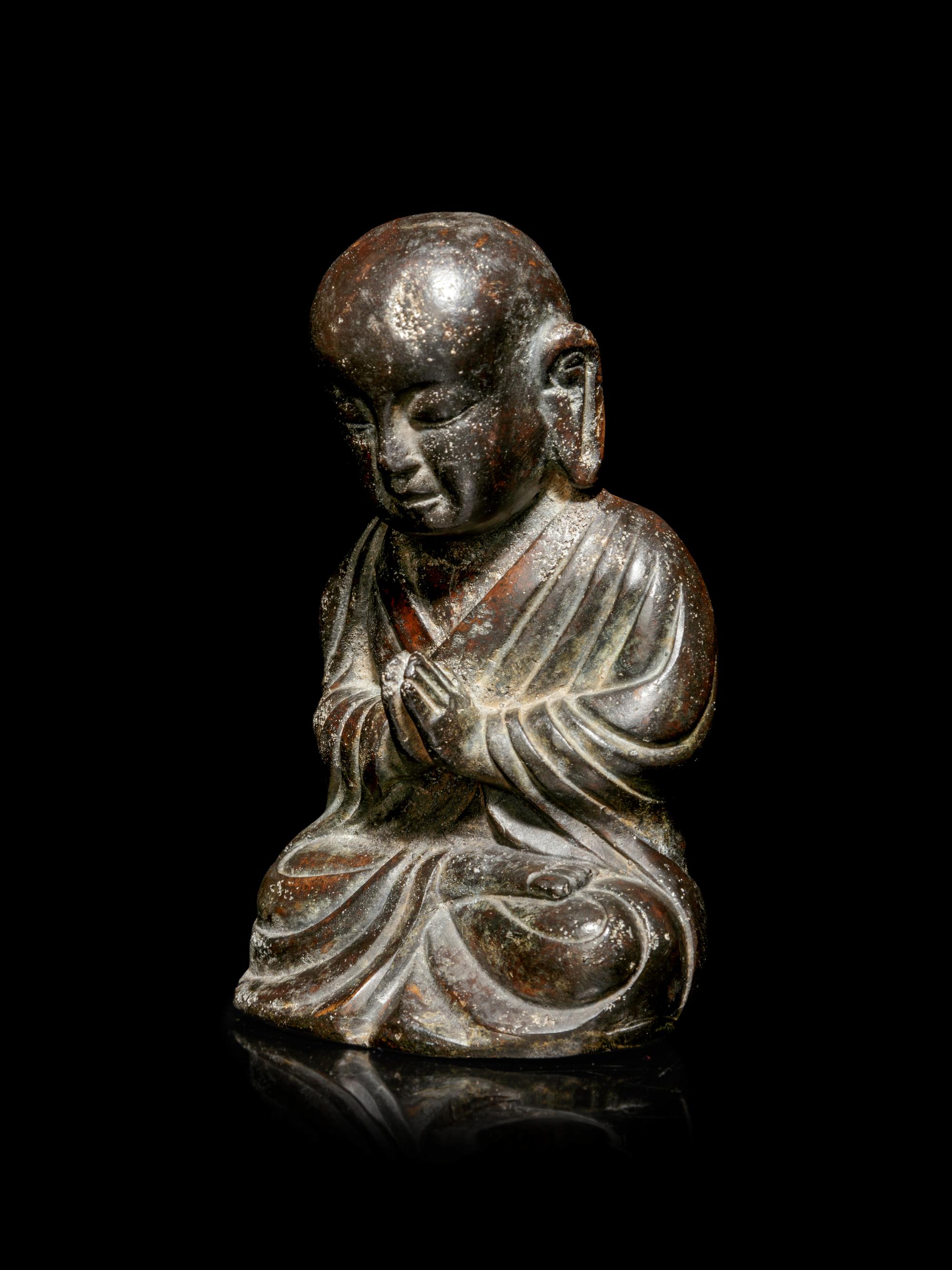 A Small Bronze Figure of a Seated Monk