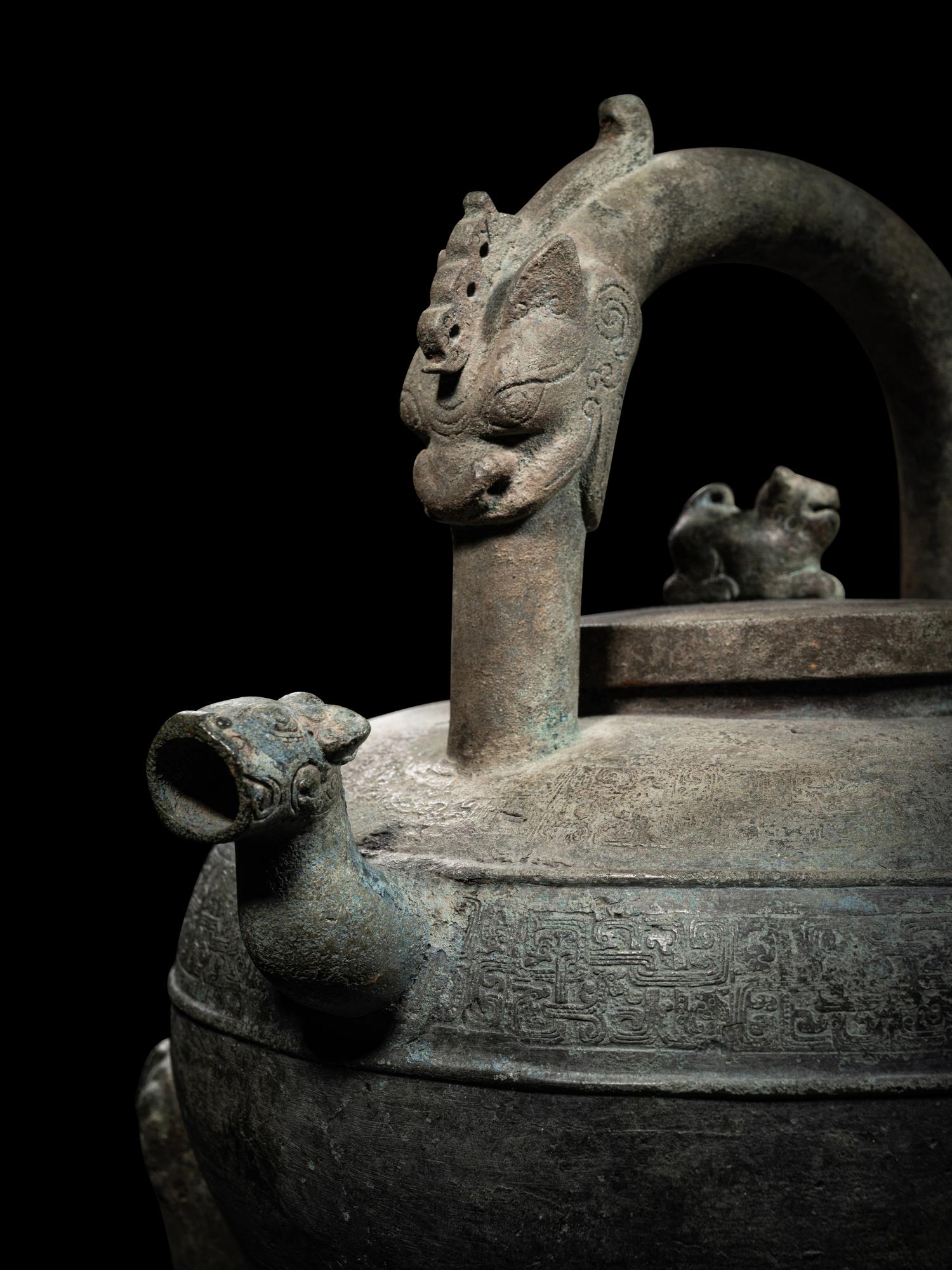 An Archaic Bronze Tripod Wine Vessel, He