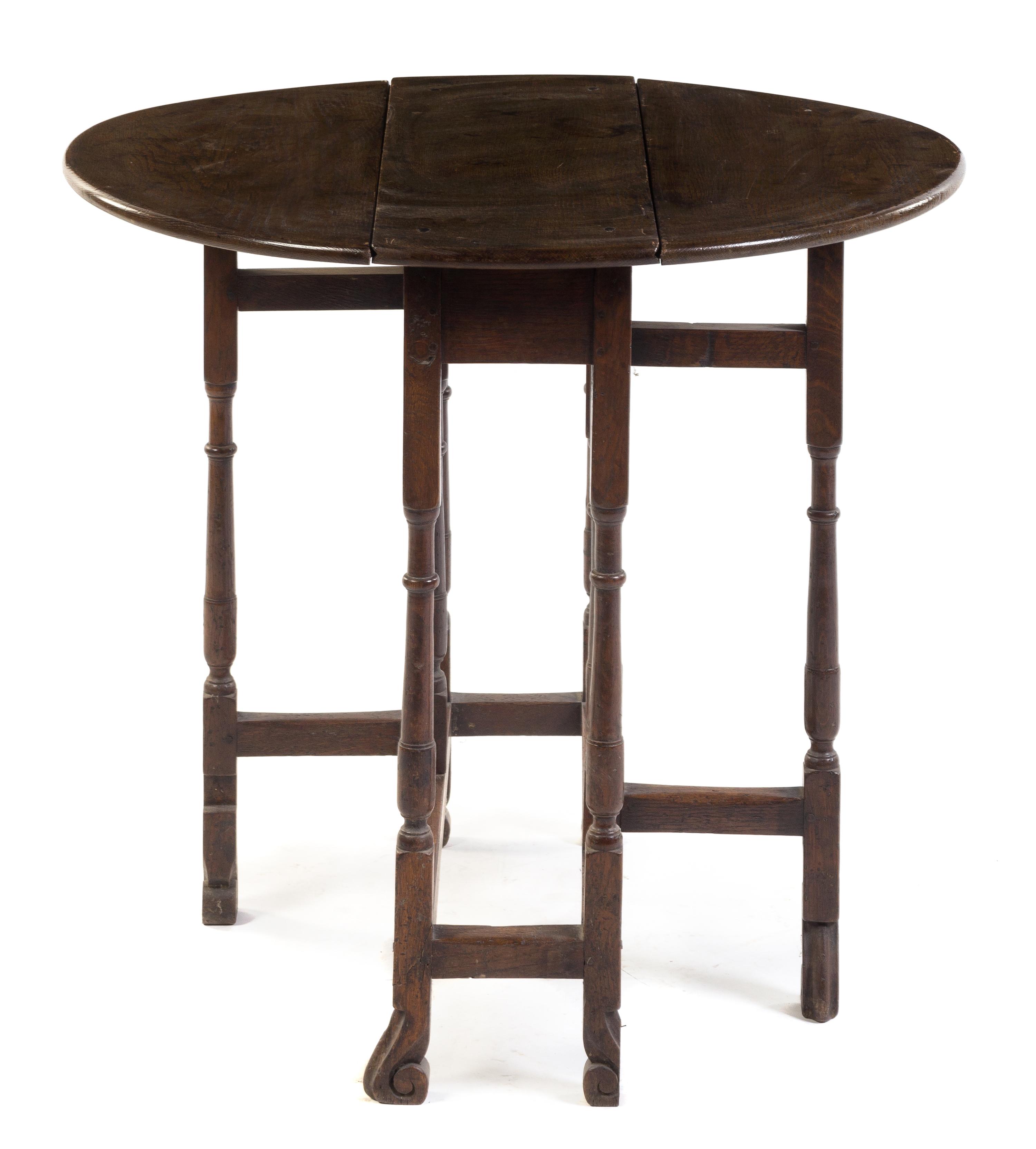 An English Oak Gate-Leg Table Height 28 1/4 x width 10 1/4 x depth 27 inches. — EARLY 20TH CENTURY