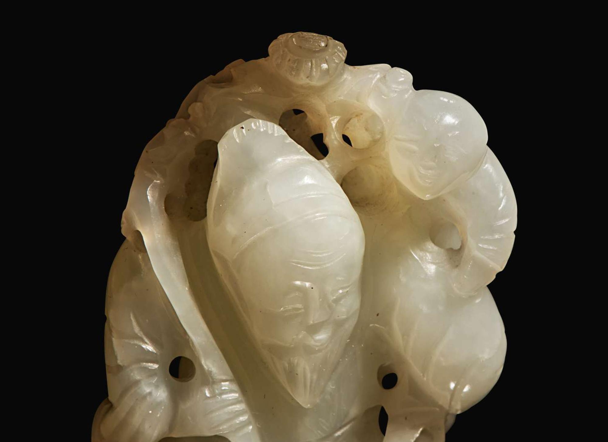A Chinese white jade figural group with carved hardwood stand 白玉人物與木座