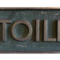 A Pair of Cast Brass and Chrome Toilete Signs 15.5" W x 3" H — Argentina, Early 20th Century