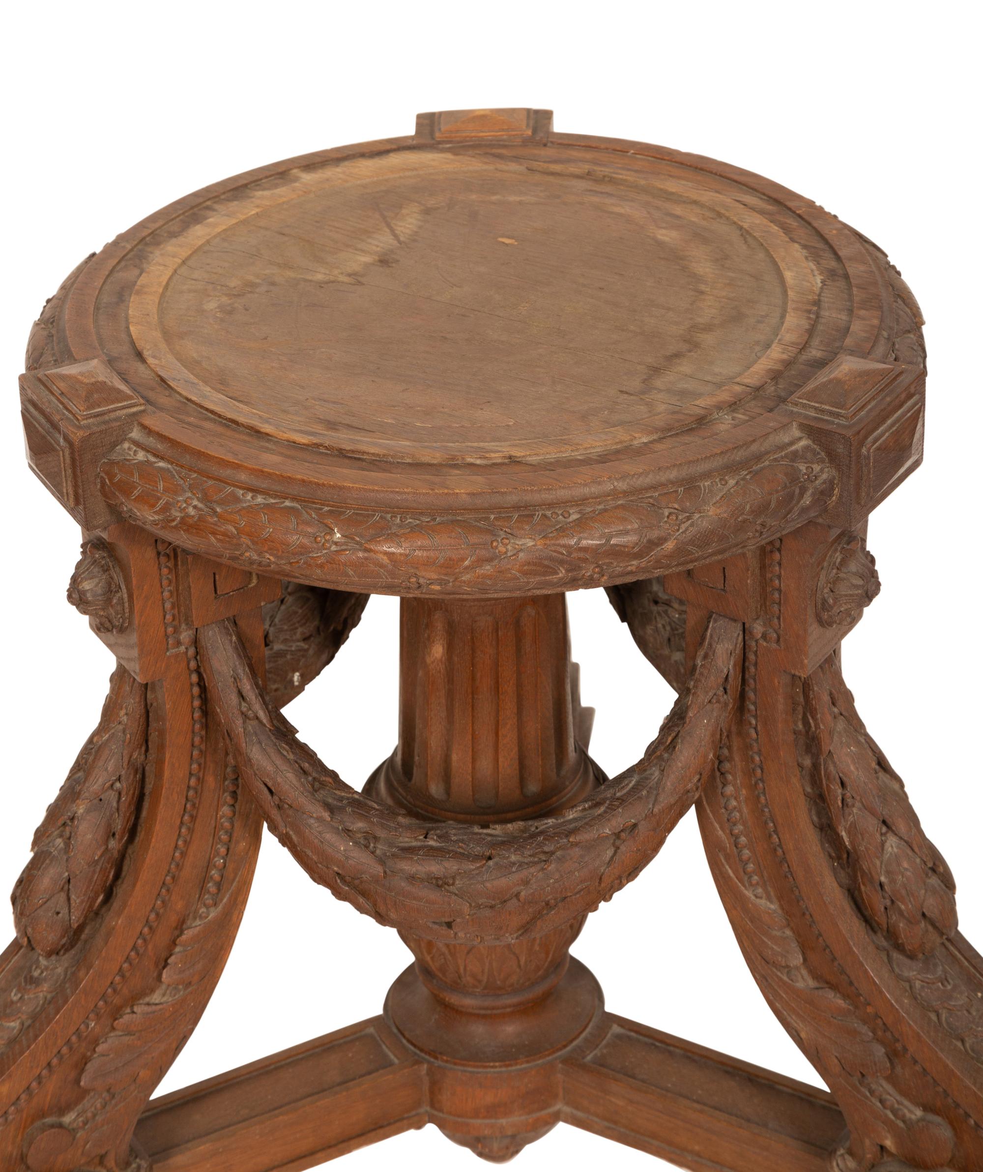 An Italian Carved Walnut Tripod Pedestal Table
