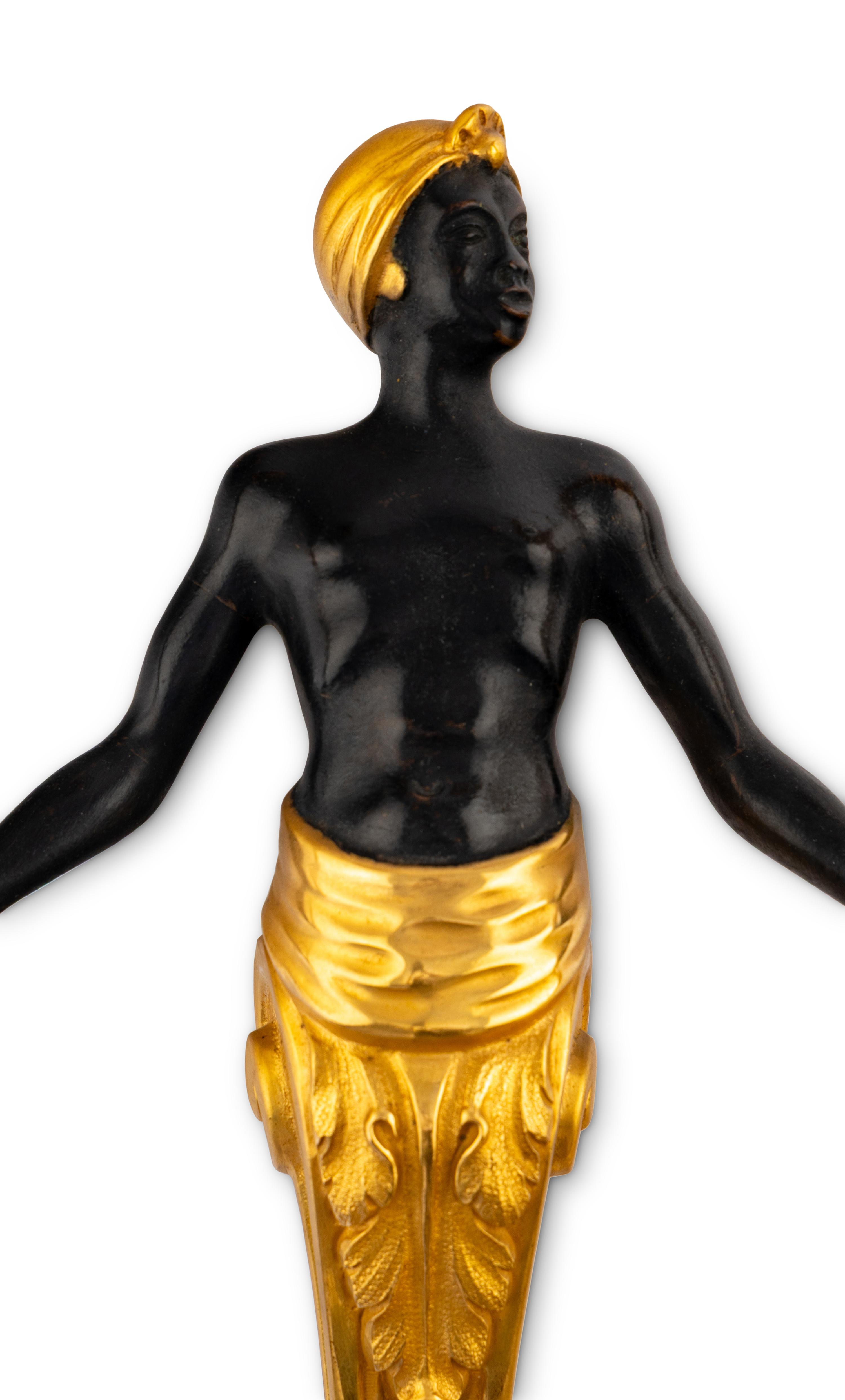 A Pair of French Gilt and Patinated Bronze Figural Two-Light Sconces
