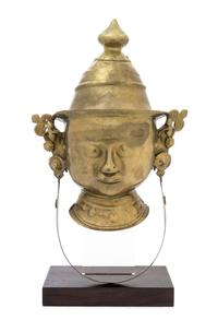 An Indian Brass Mask of Parvati 18TH/19TH CENTURY Height on stand 19 1/2 x width 11 1/2 inches. — 18TH/19TH CENTURY