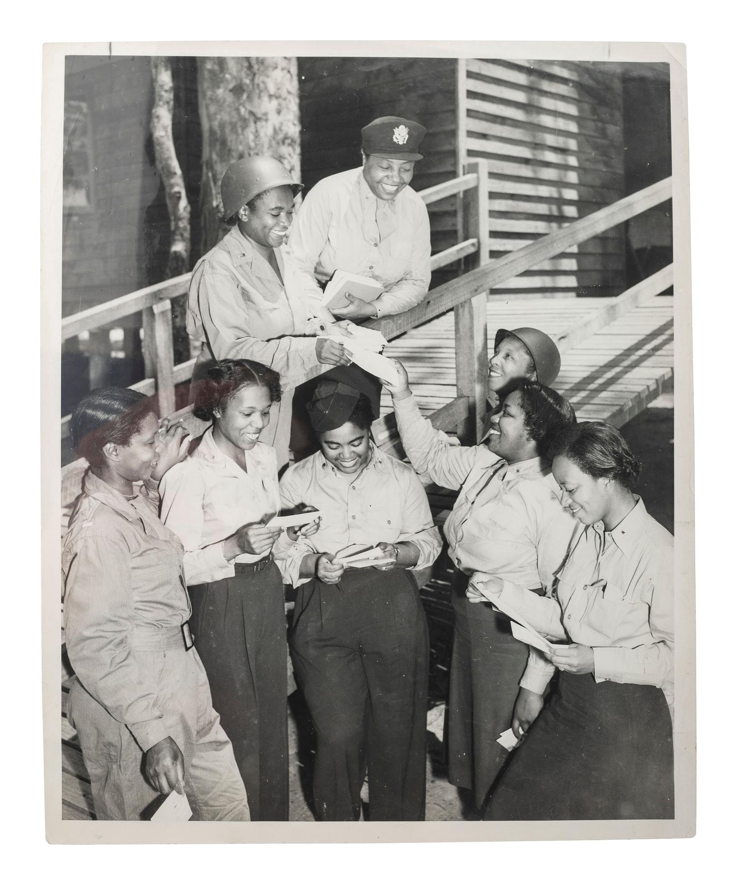 [WORLD WAR II & VIETNAM]. A group of 14 snapshots including portraits of prize fighter Toikey Thompson and black female combat nurses, including: