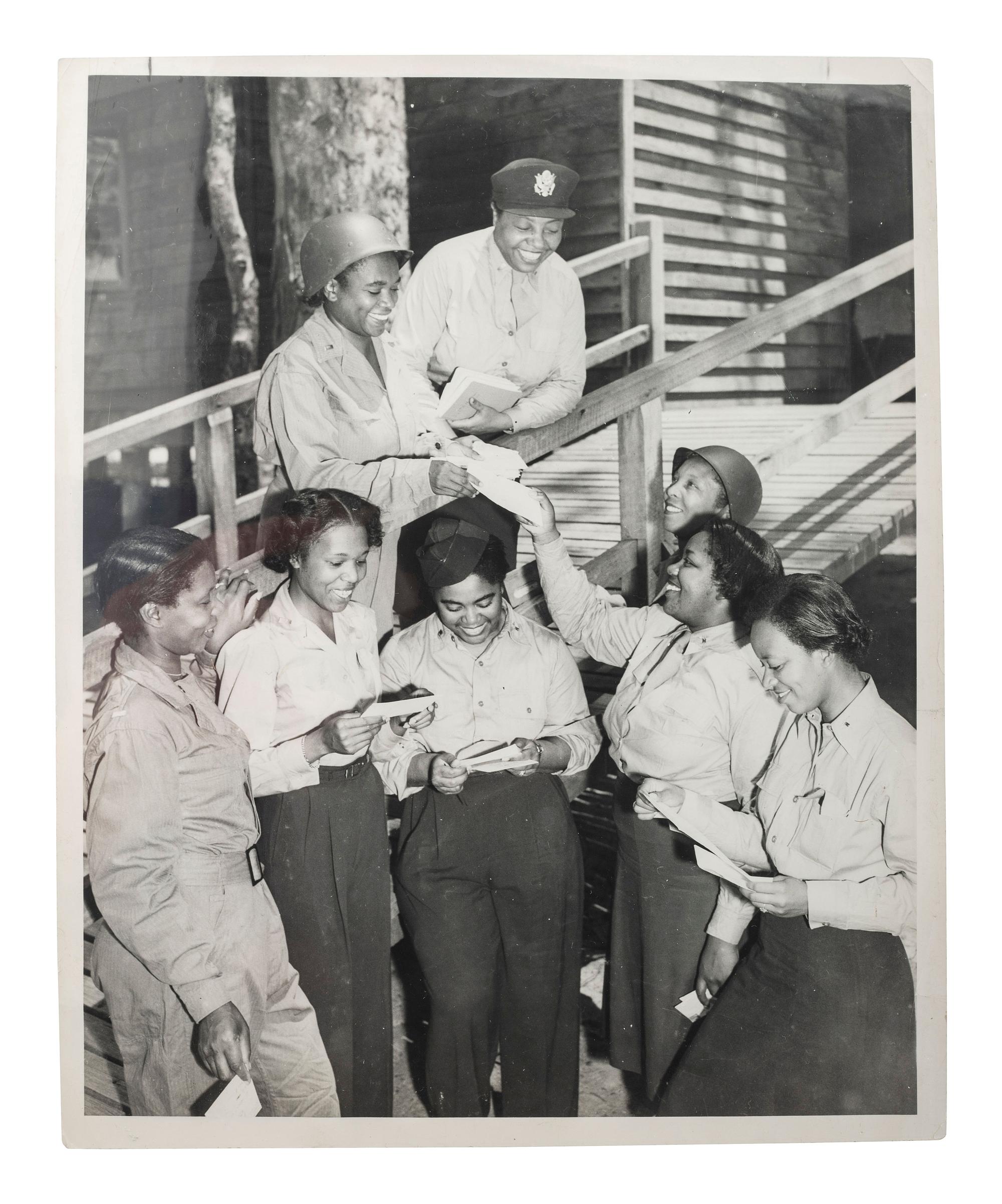 [WORLD WAR II & VIETNAM]. A group of 14 snapshots including portraits of prize fighter Toikey Thompson and black female combat nurses, including: