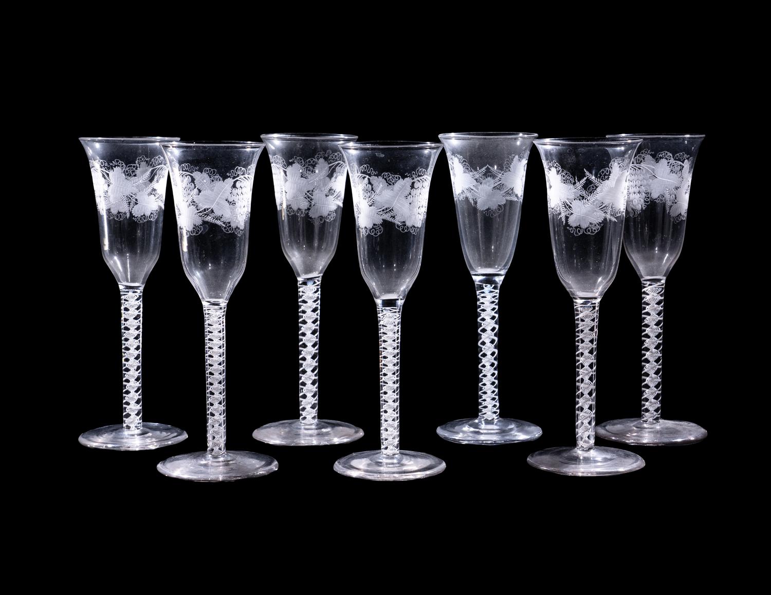 A Set of Seven Engraved Glass Cordials with Twist Stems