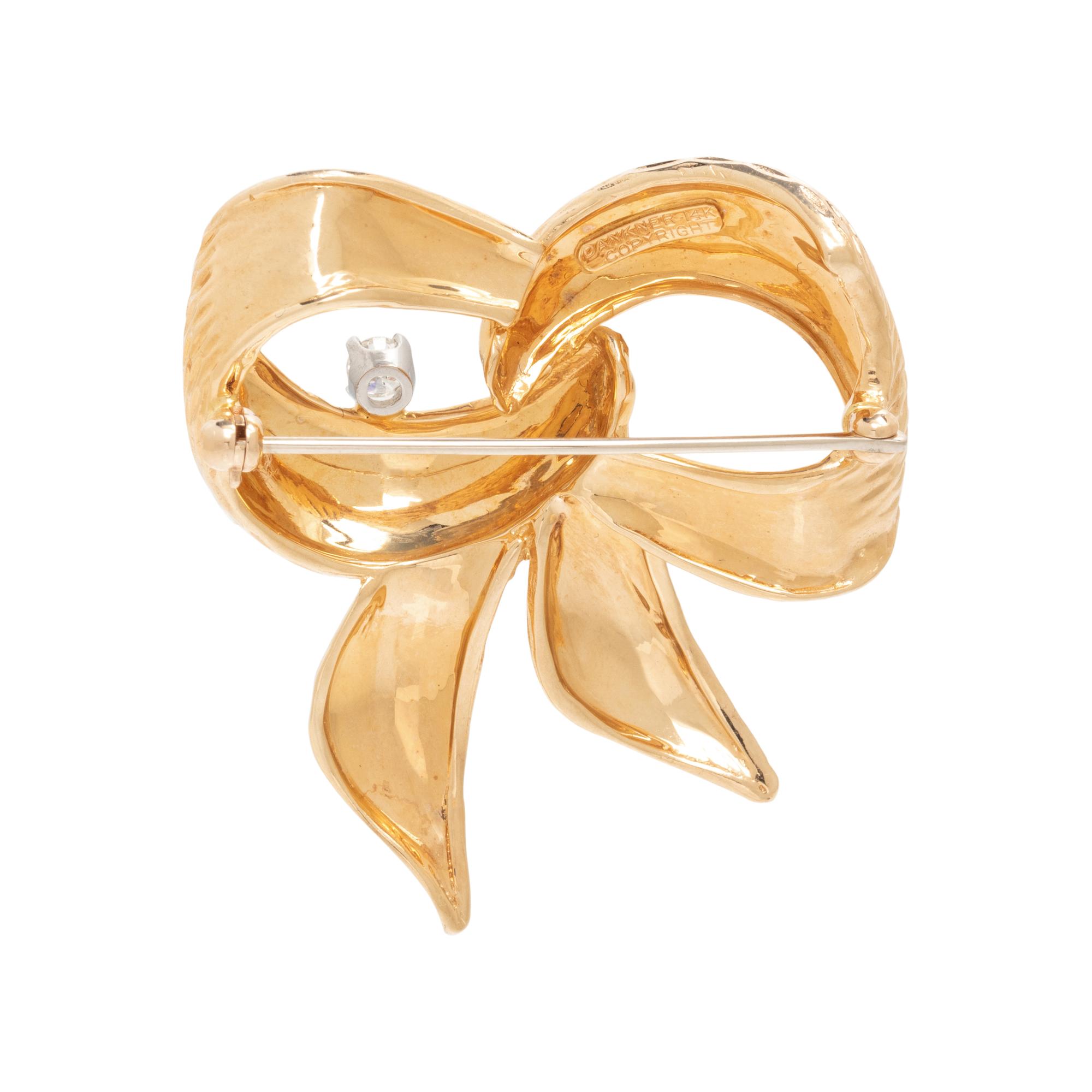 HENRY DANKNER, YELLOW GOLD AND DIAMOND BOW BROOCH