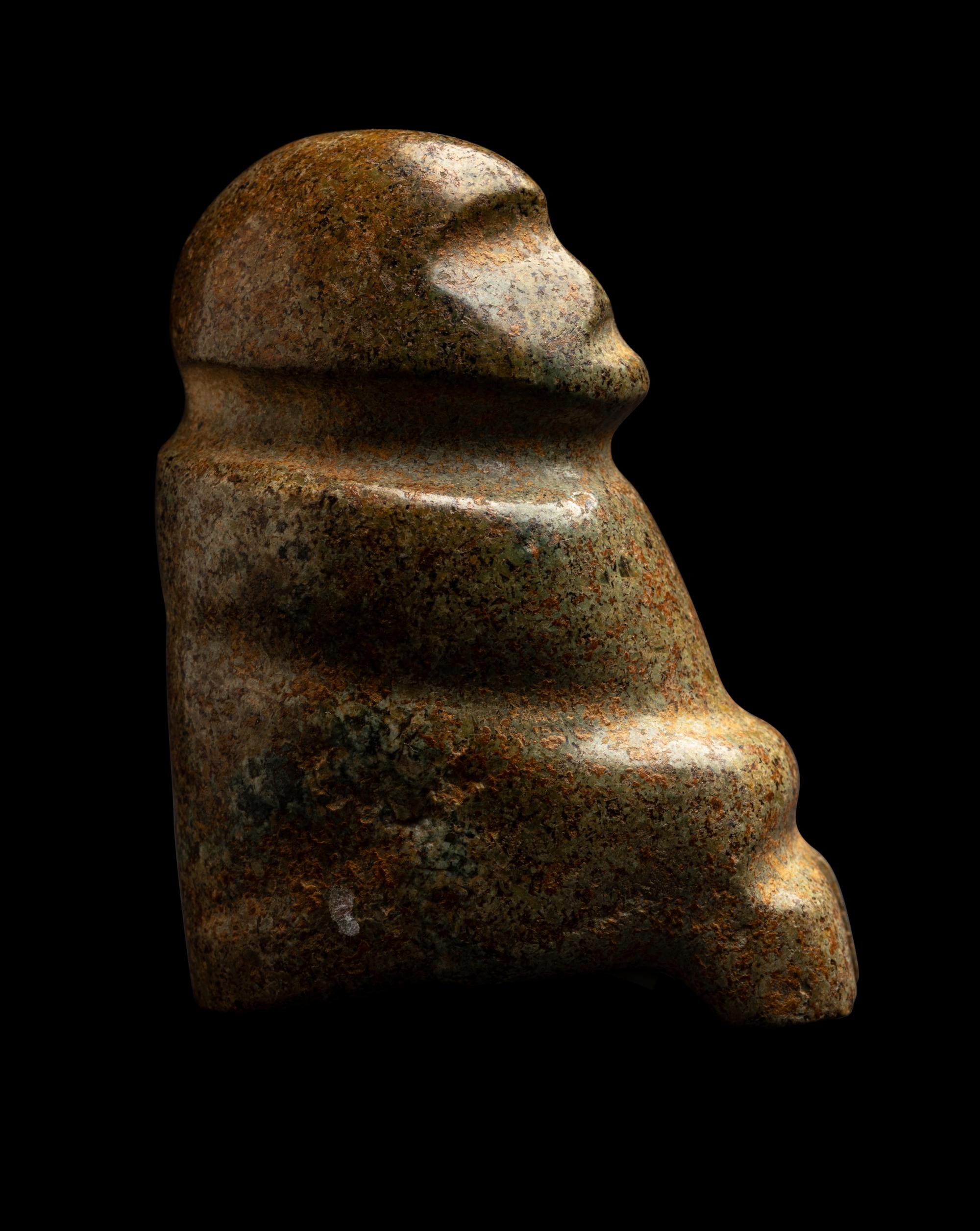 A Mezcala Green-White Stone Seated Figure