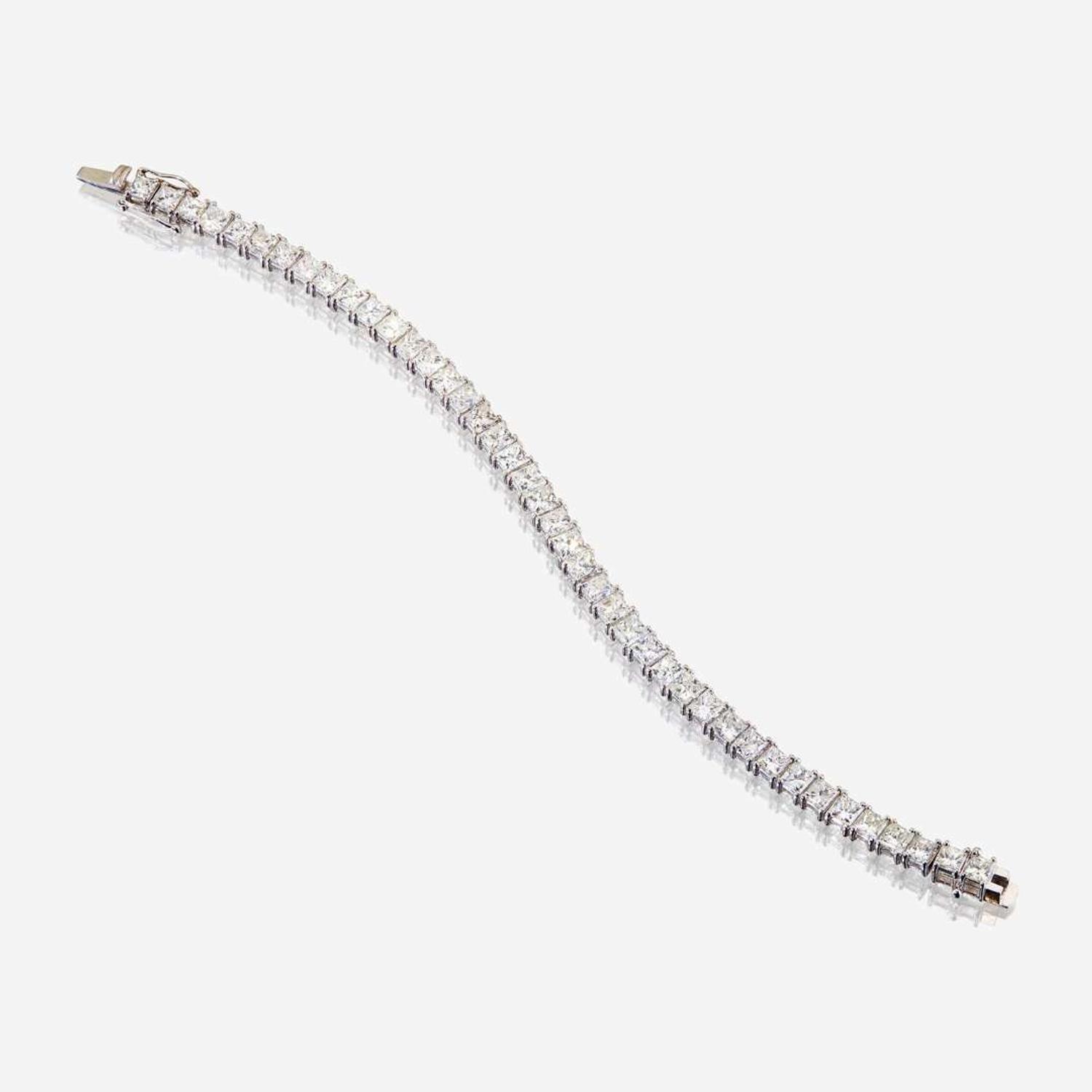 A diamond and fourteen karat white gold line bracelet