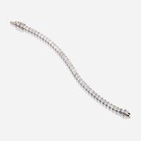 A diamond and fourteen karat white gold line bracelet