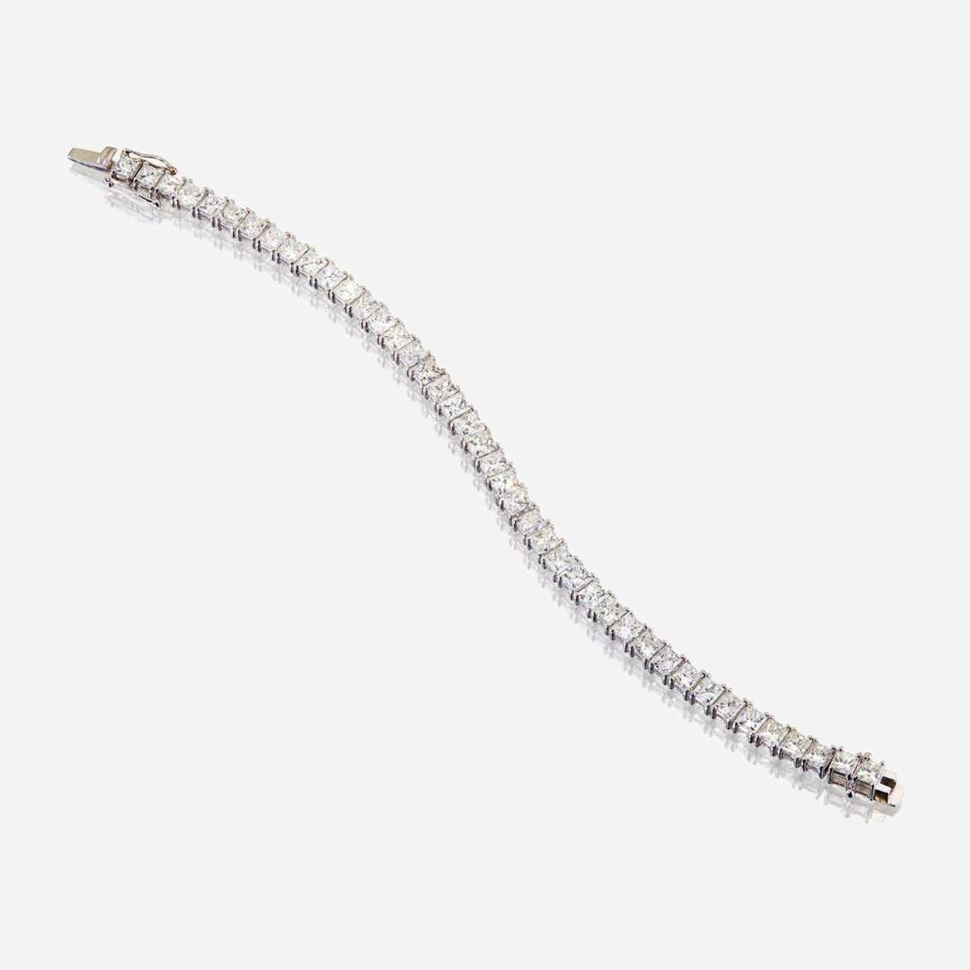 A diamond and fourteen karat white gold line bracelet