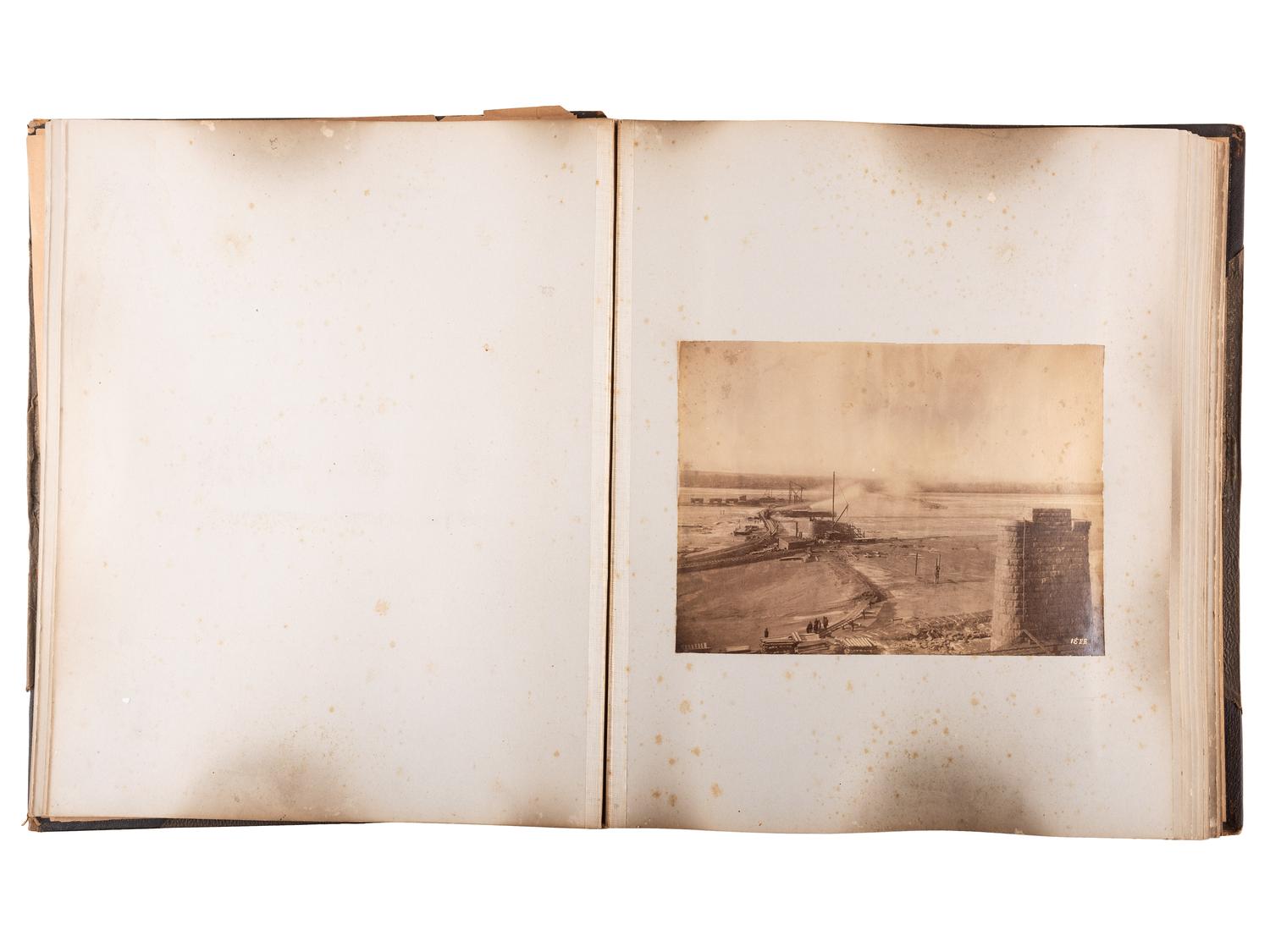 [WESTERN AMERICANA]. Album of photographs showing the construction of the "Bismarck Bridge." [Dakota Territory]: [F. Jay Haynes], [1882].