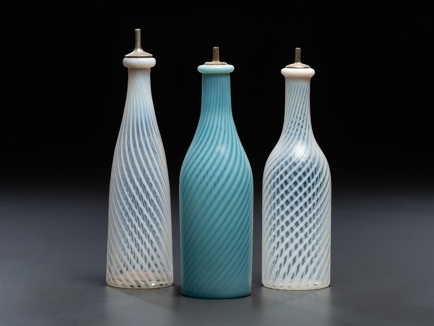 Three Opalescent Swirl Glass Barber Bottles