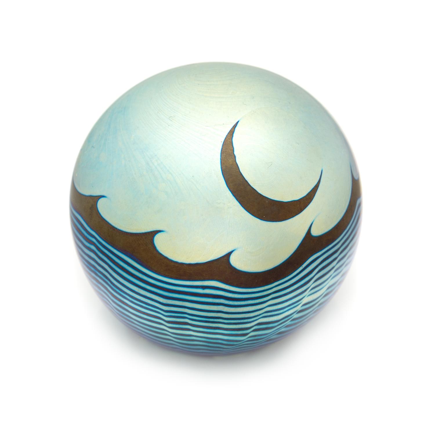 Correia Art Glass, Fountain Valley, California, a moon and waves iridescent surface-design paperweight