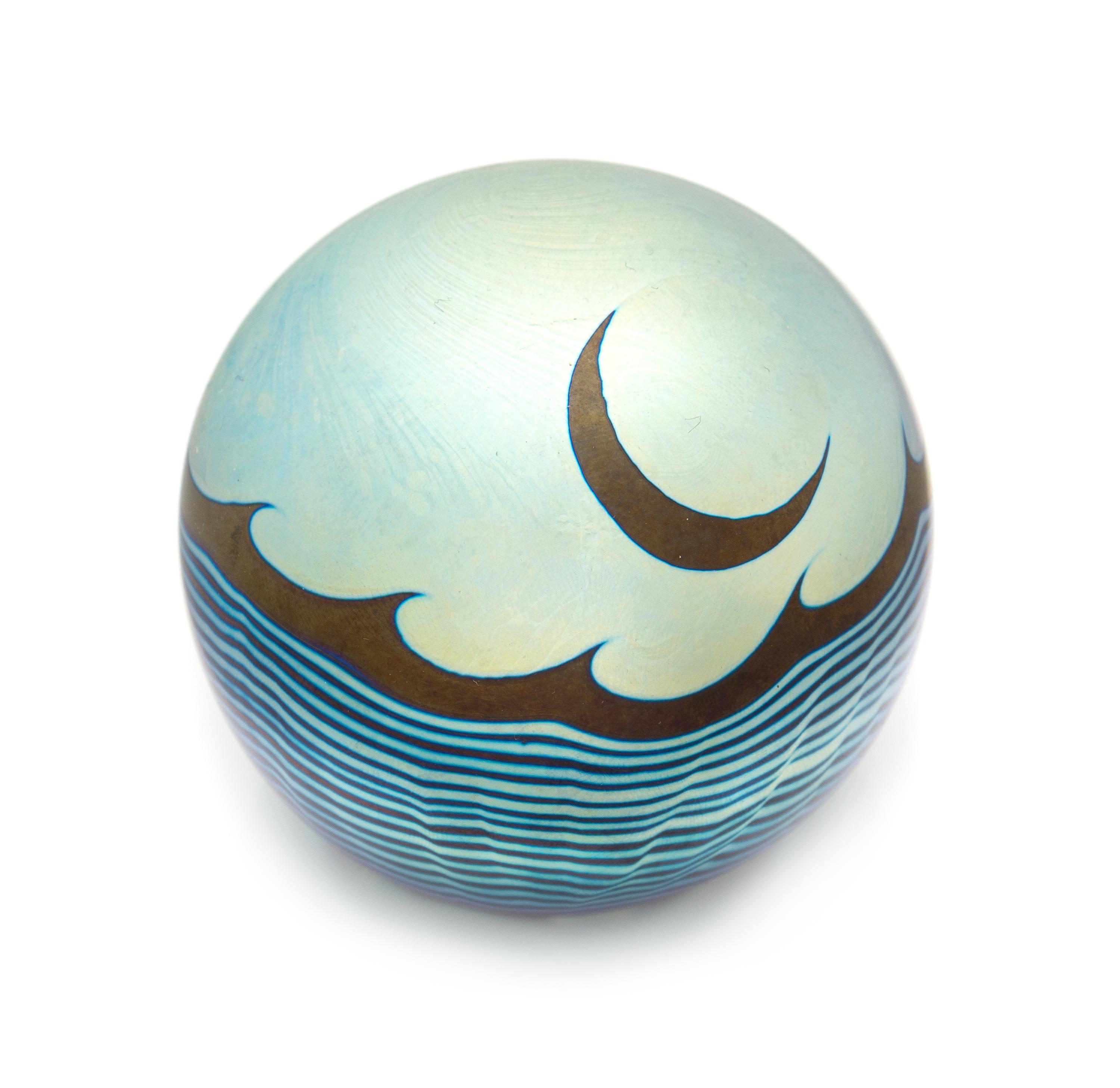 Correia Art Glass, Fountain Valley, California, a moon and waves iridescent surface-design paperweight