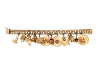 A 14 Karat Yellow Gold Charm Bracelet with 15 Attached Charms,