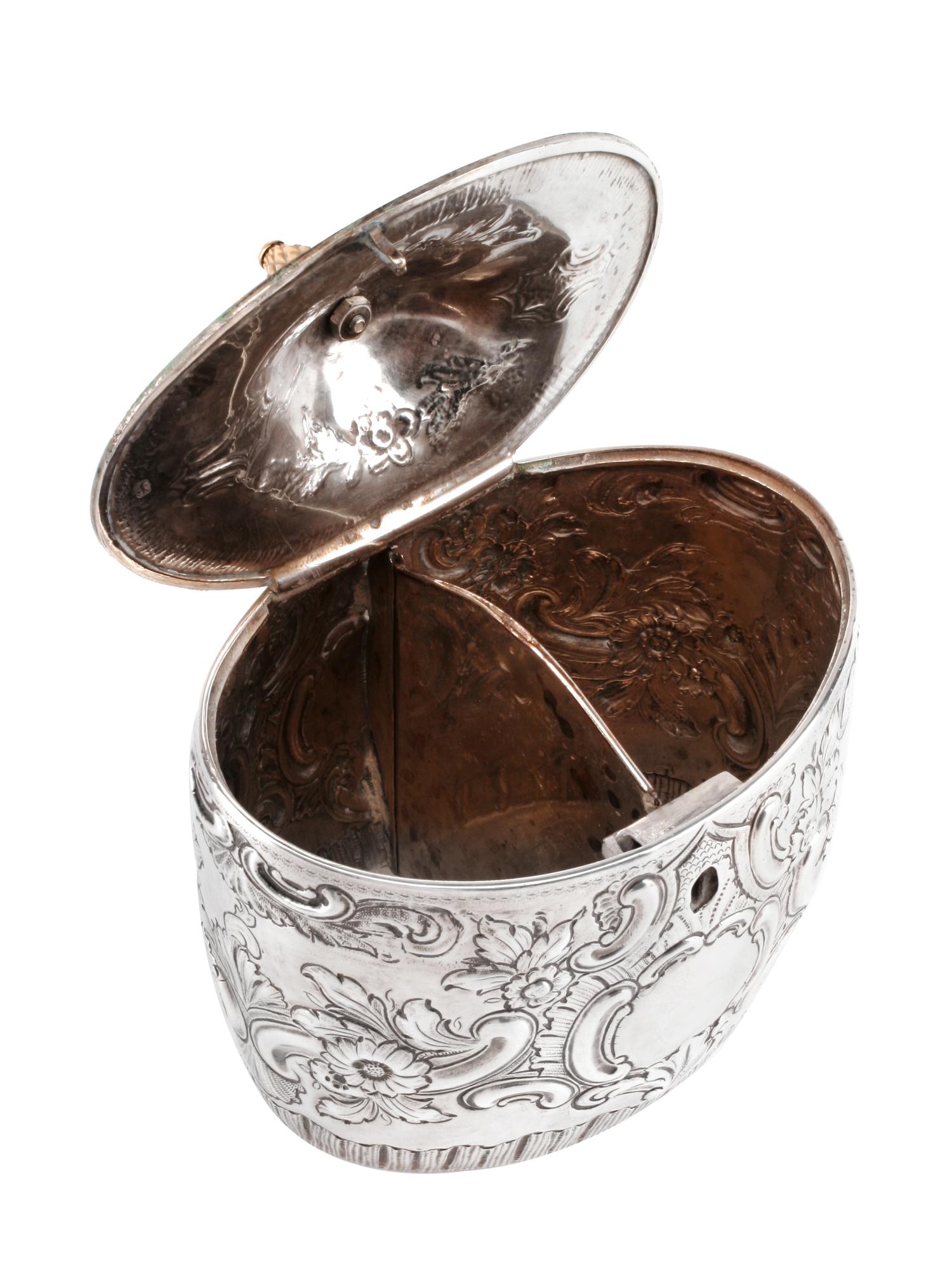 An English Silver Tea Caddy, John Schofield, London, 1794, the oval domed lid with a pinecone finial, the body bearing a vacant cartouc