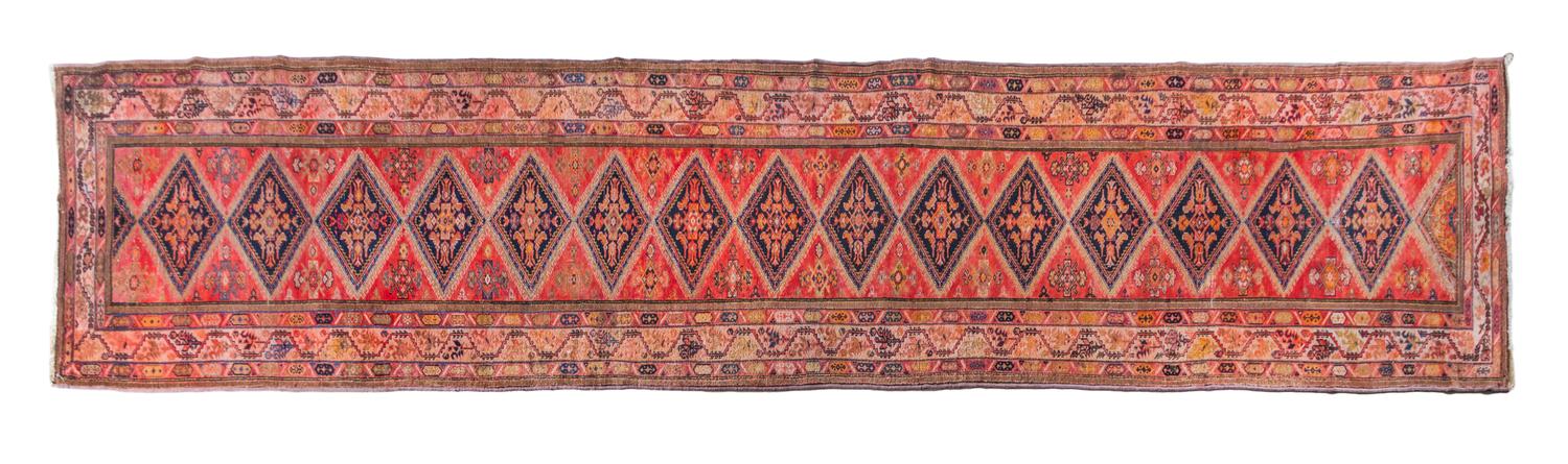 A Persian Wool Runner 20 feet 2 inches x 3 feet 3 inches.