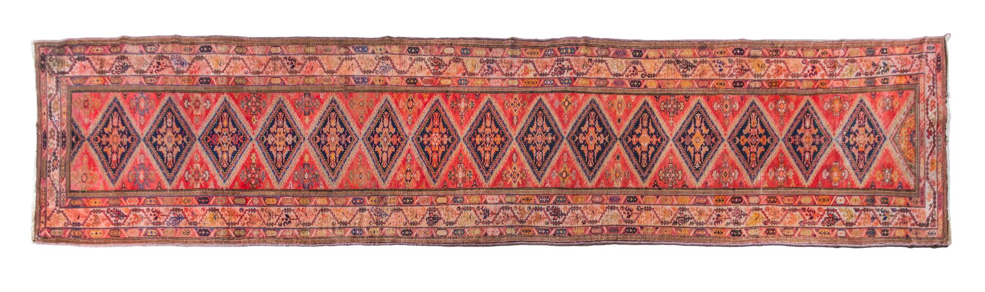 A Persian Wool Runner 20 feet 2 inches x 3 feet 3 inches.