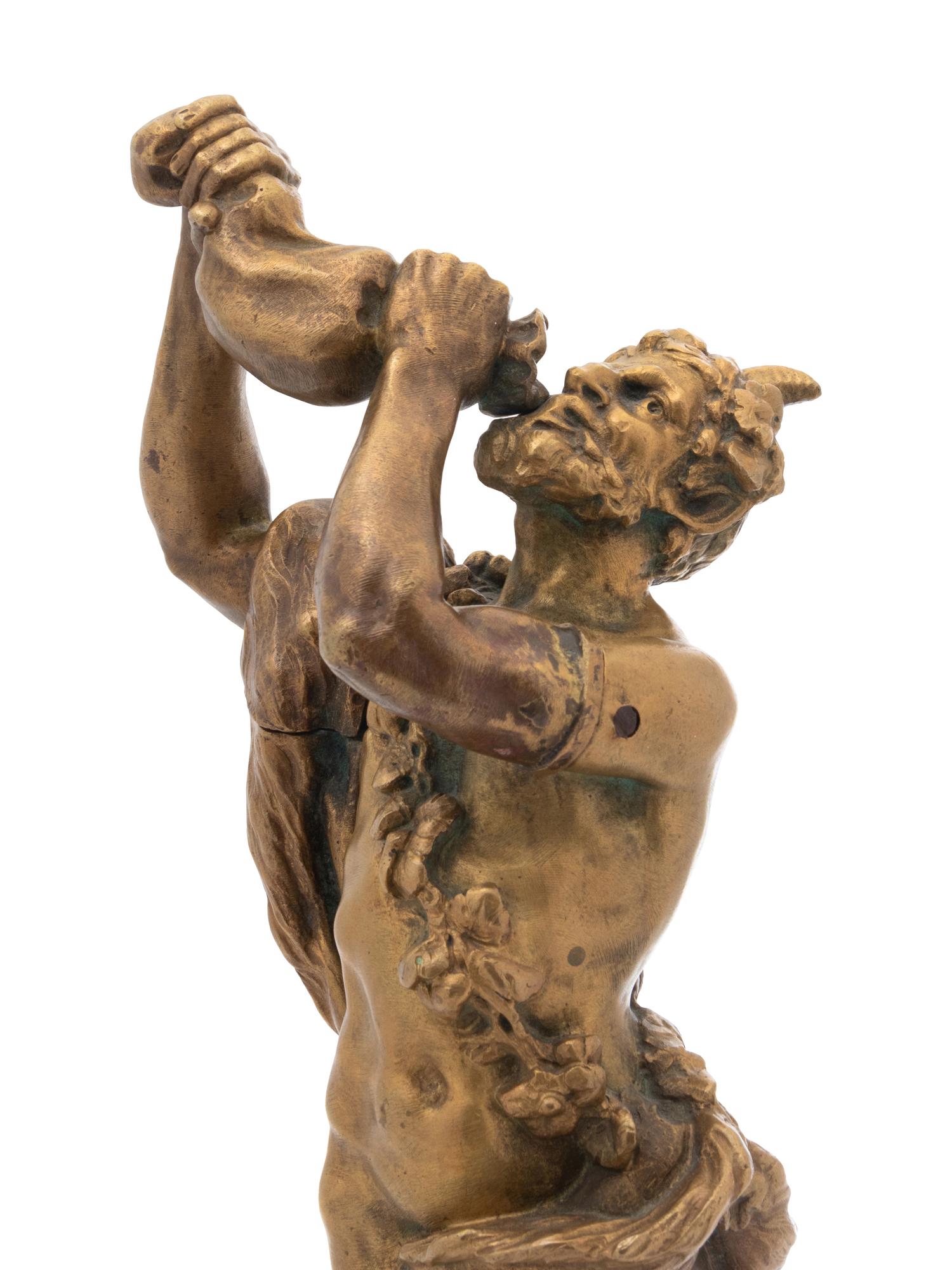 A Continental Gilt Bronze Figure of a Satyr Drinking from a Wine Skin
