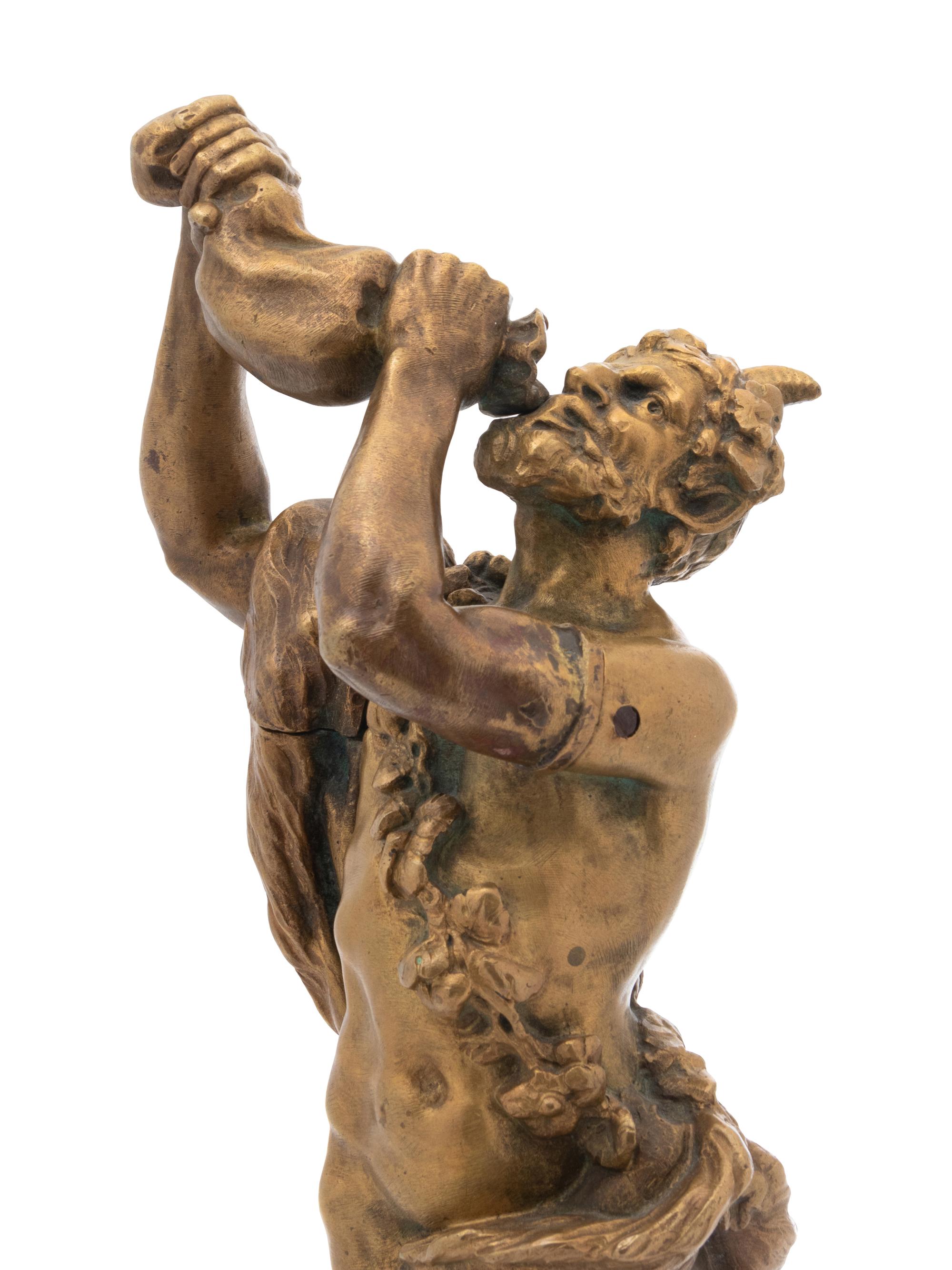 A Continental Gilt Bronze Figure of a Satyr Drinking from a Wine Skin