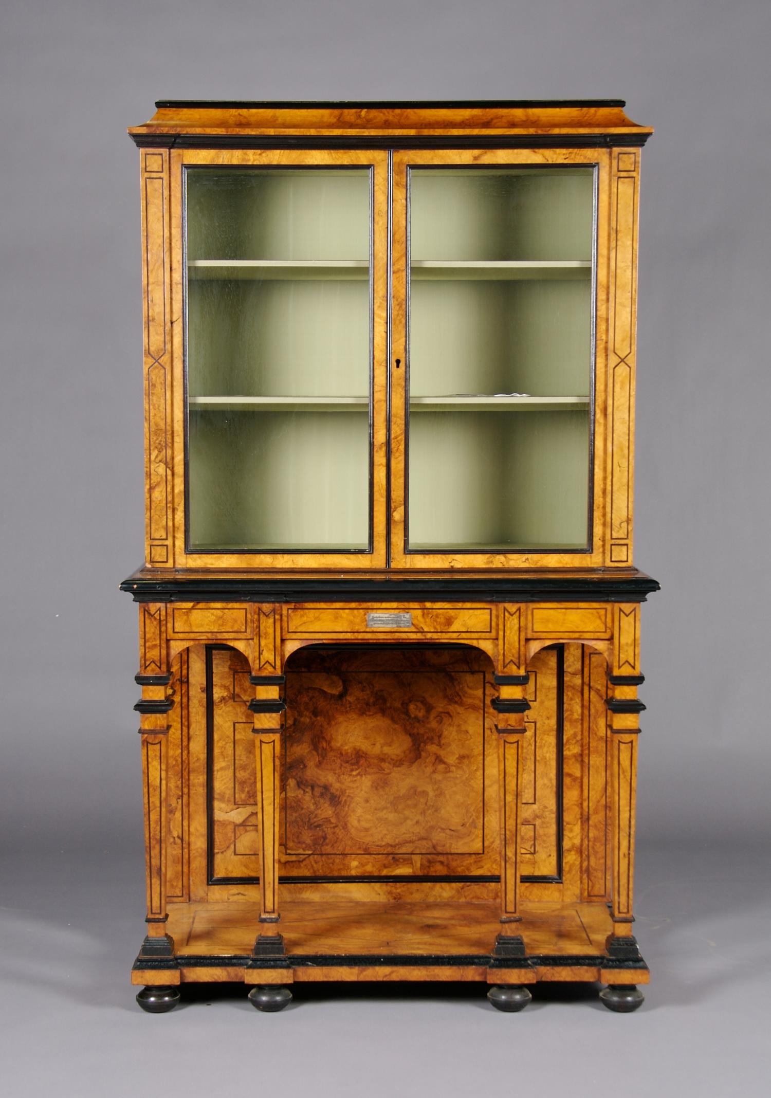 A Continental Burlwood and Ebonized Cabinet on Stand, Height 61 3/4 x width 36 1/4 x depth 17 1/4 inches.